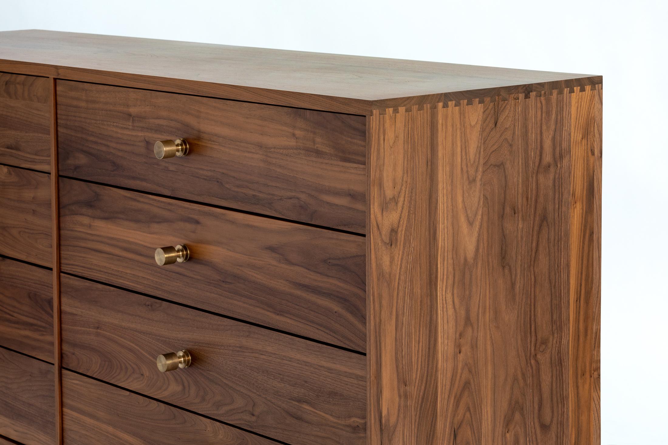 This handmade credenza or dresser console features bronze pulls, dovetail joinery and a blackened steel base. The AC11 stands with confidence and adds elegance to any work or living environment.

Shown in solid walnut, with a blackened steel base