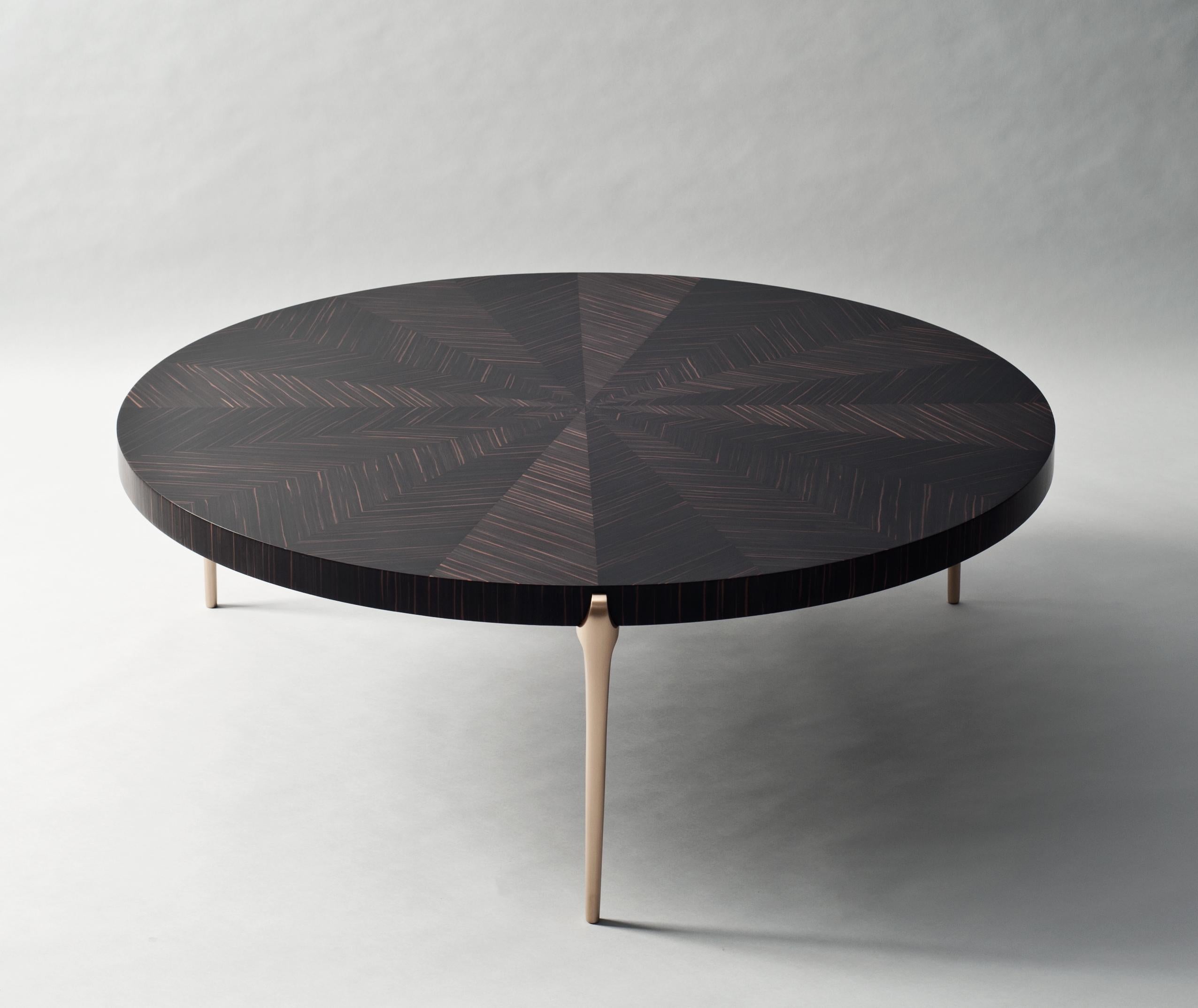 Acantha coffee table by DeMuro Das 
Dimensions: W 120 x D 120 x H 41.1 cm
Materials: Matte Swiss ebony tabletop 
 Solid bronze - Satin legs

Dimensions and finishes can be customized.

DeMuro Das is an international design firm and the aesthetic and