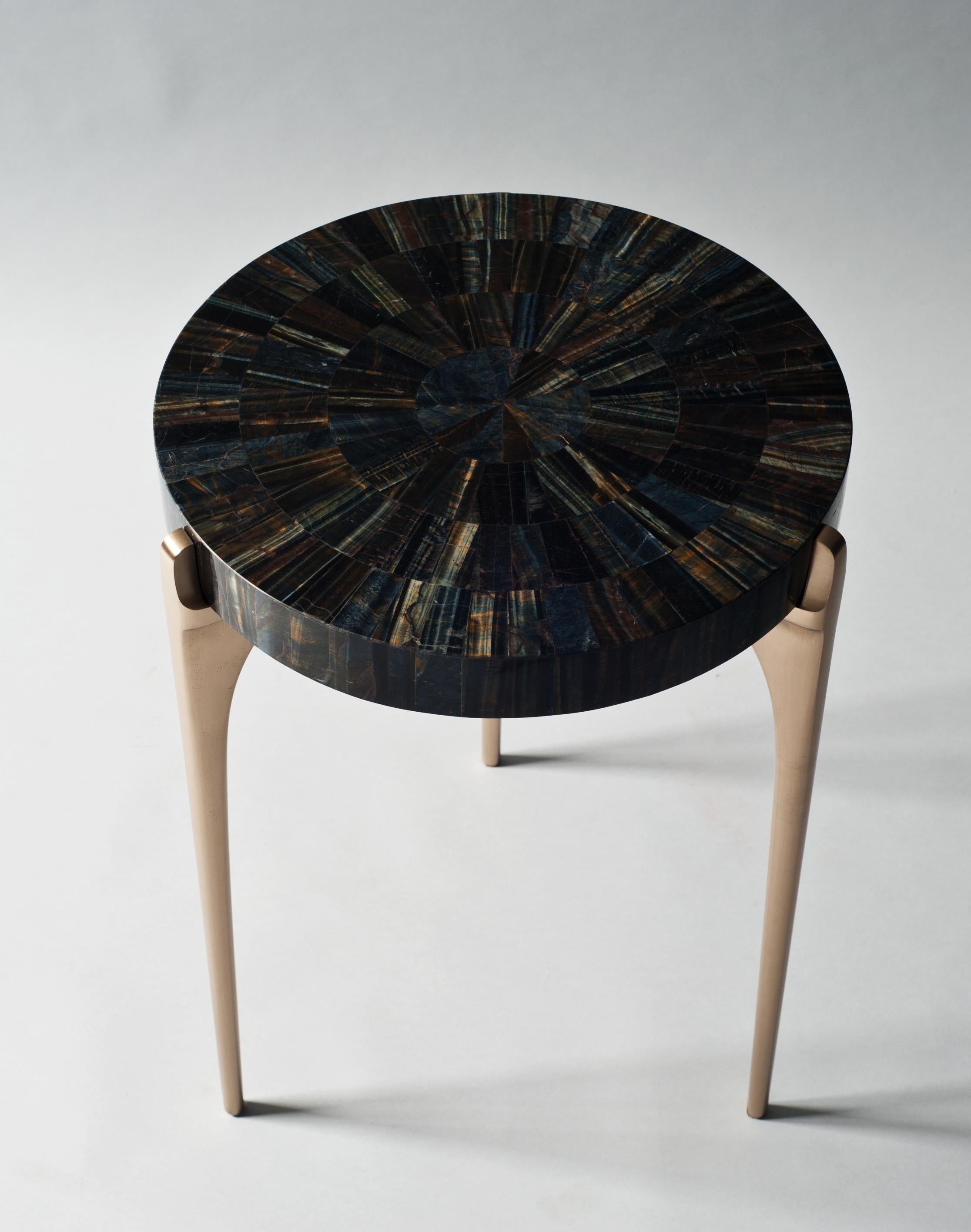 Acantha side table by DeMuro Das 
Dimensions: 41.5 x 55.25 cm
Materials: Tiger's Eye (Blue) - Polished (Tiled) Tabletop
 Solid Bronze - Satin legs

Dimensions and finishes can be customized, please contact us.

DeMuro Das is an international