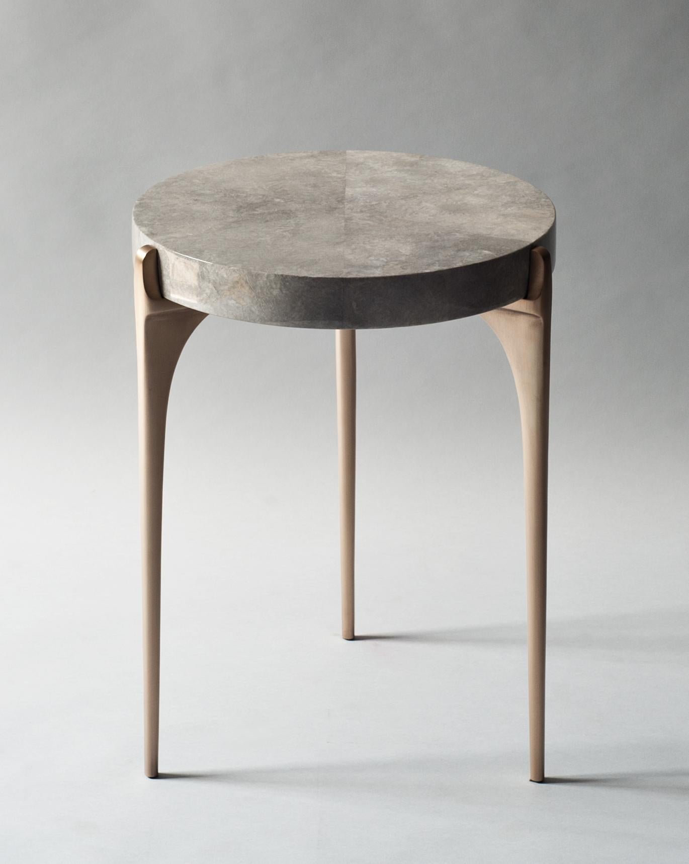 Acantha side table by DeMuro Das
Dimensions: 41.5 x 54.5 cm
Materials: Carta (Grey), glossy
Solid Bronze, satin legs

Dimensions and finishes can be customized.

DeMuro Das is an international design firm and the aesthetic and cultural