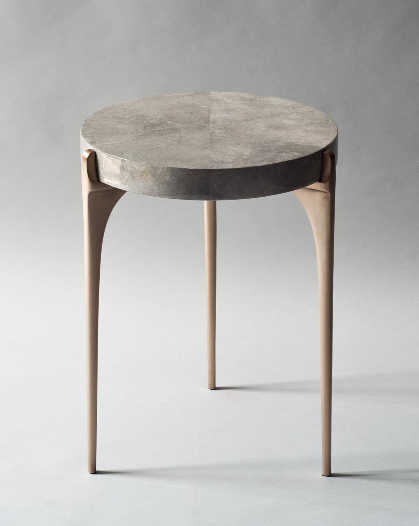 Acantha side table by DeMuro Das
Dimensions: 41.5 x 54.5 cm
Materials: Carta (Grey), glossy
Solid bronze, satin legs

Dimensions and finishes can be customized.

DeMuro Das is an international design firm and the aesthetic and cultural