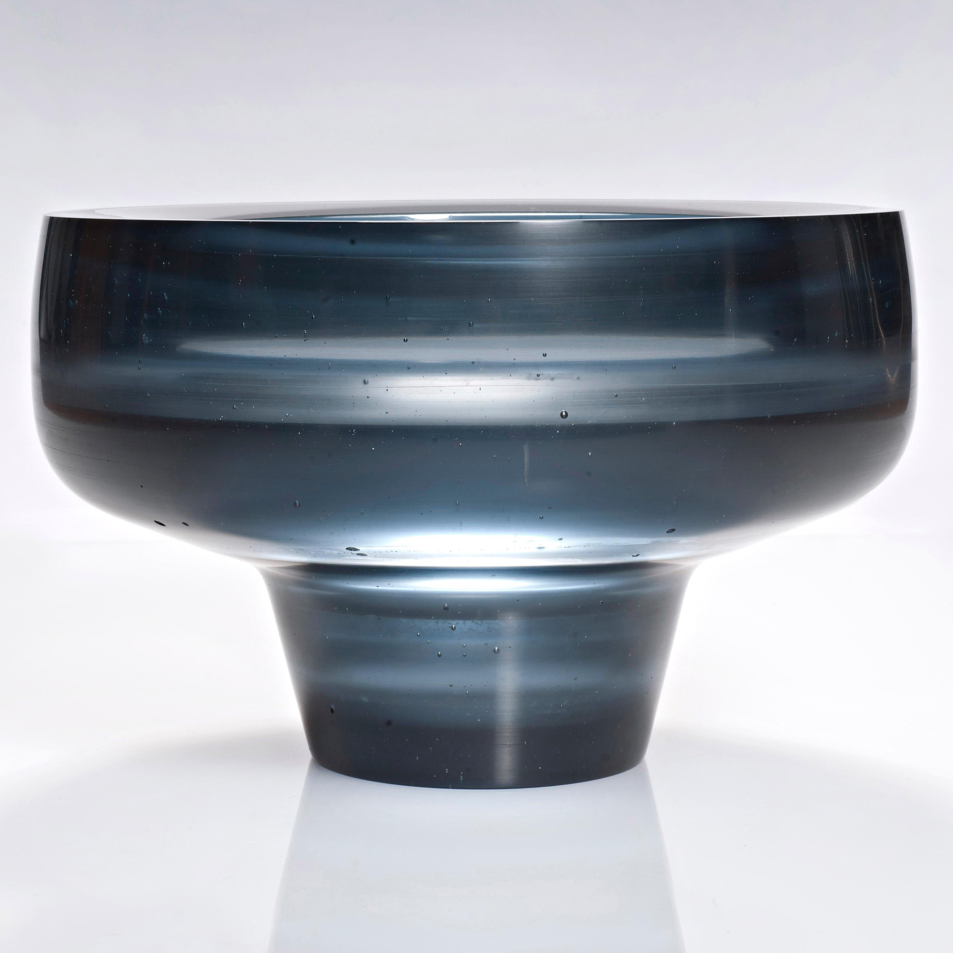 Acanthe is a cast glass artwork in a beautiful steel blue by the British artist Paul Stopler. With a smooth exterior, the interior is stepped into sections with ridged protruding 