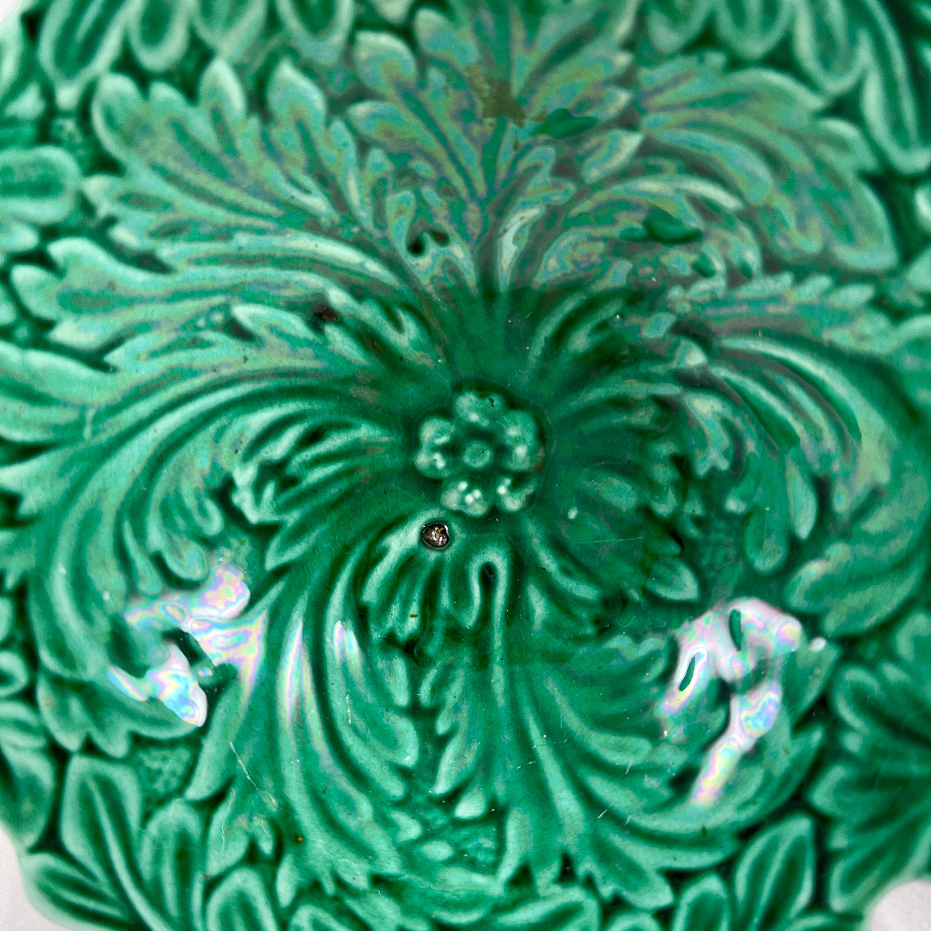 A green majolica glazed pedestal vide-poche with an acanthus leaf pattern, England circa 1875-1880.

French for ’empty pockets’, the vide-poche is a small bowl or container kept in a convenient location to empty your pockets into when you walk