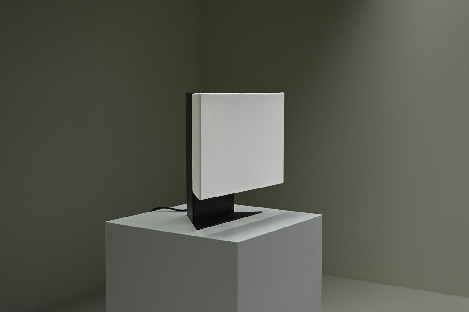 Accademia table lamp from Cini Boeri for Artemide, 1970s Italy. Elevate your interior with the minimalist elegance of the Accademia table lamp by renowned Italian designer Cini Boeri. This piece features a striking geometric form with a bold