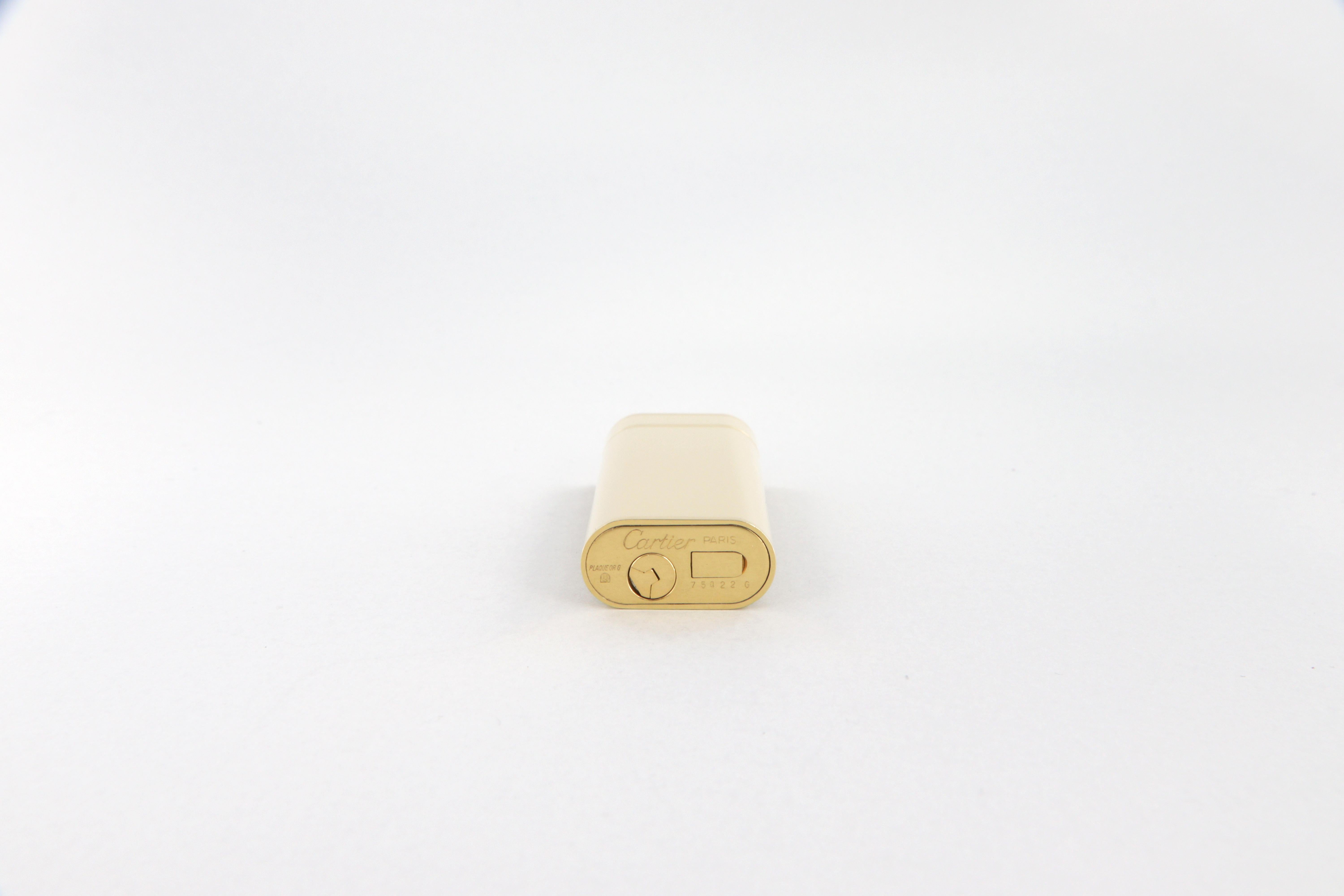 Les Must de Cartier oval gold-plated and ivory lacquer lighter 1