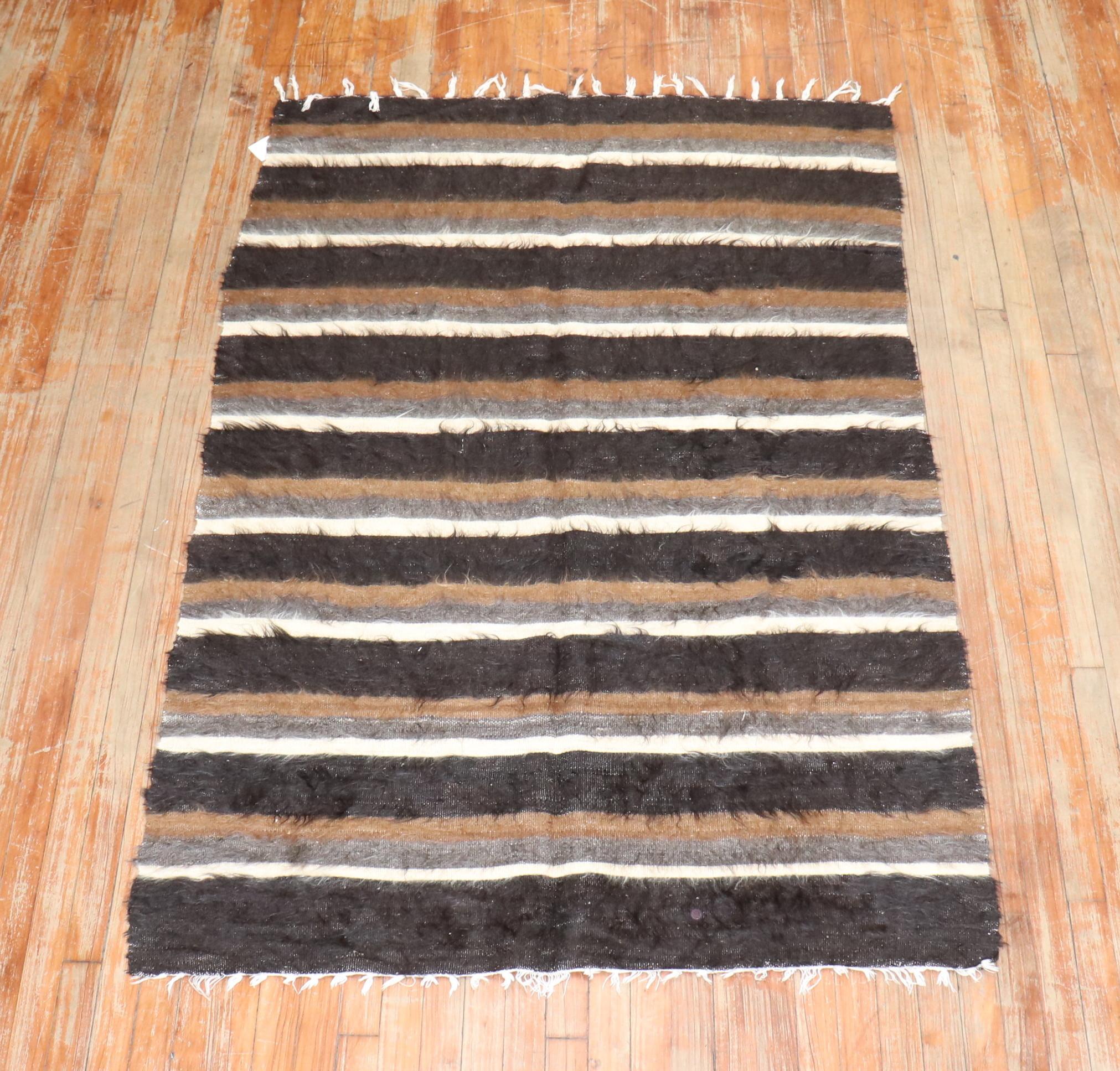 A Mid-20th Century one-of-a-kind Turkish Mohair Sirt rug woven with mohair wool. These pieces are inspired by traditional tribal weaving's but they are used mostly for decorative purposes and have a strong modernist appeal. The unique pile technique