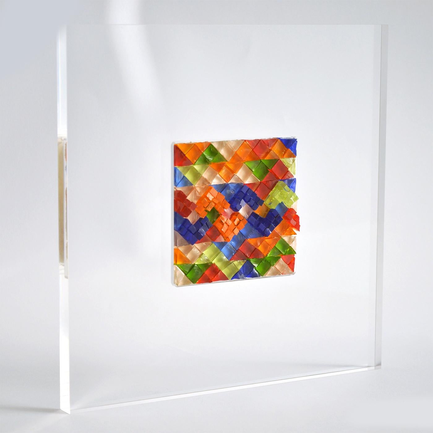Artist Nino Basso decided to create a modern revisitation of the ancient splendour of Roman and Byzantine mosaic works in this contemporary mosaic tableau. The tableau’s white crystal acrylic frame is a clean backdrop for the Stark, bright colours