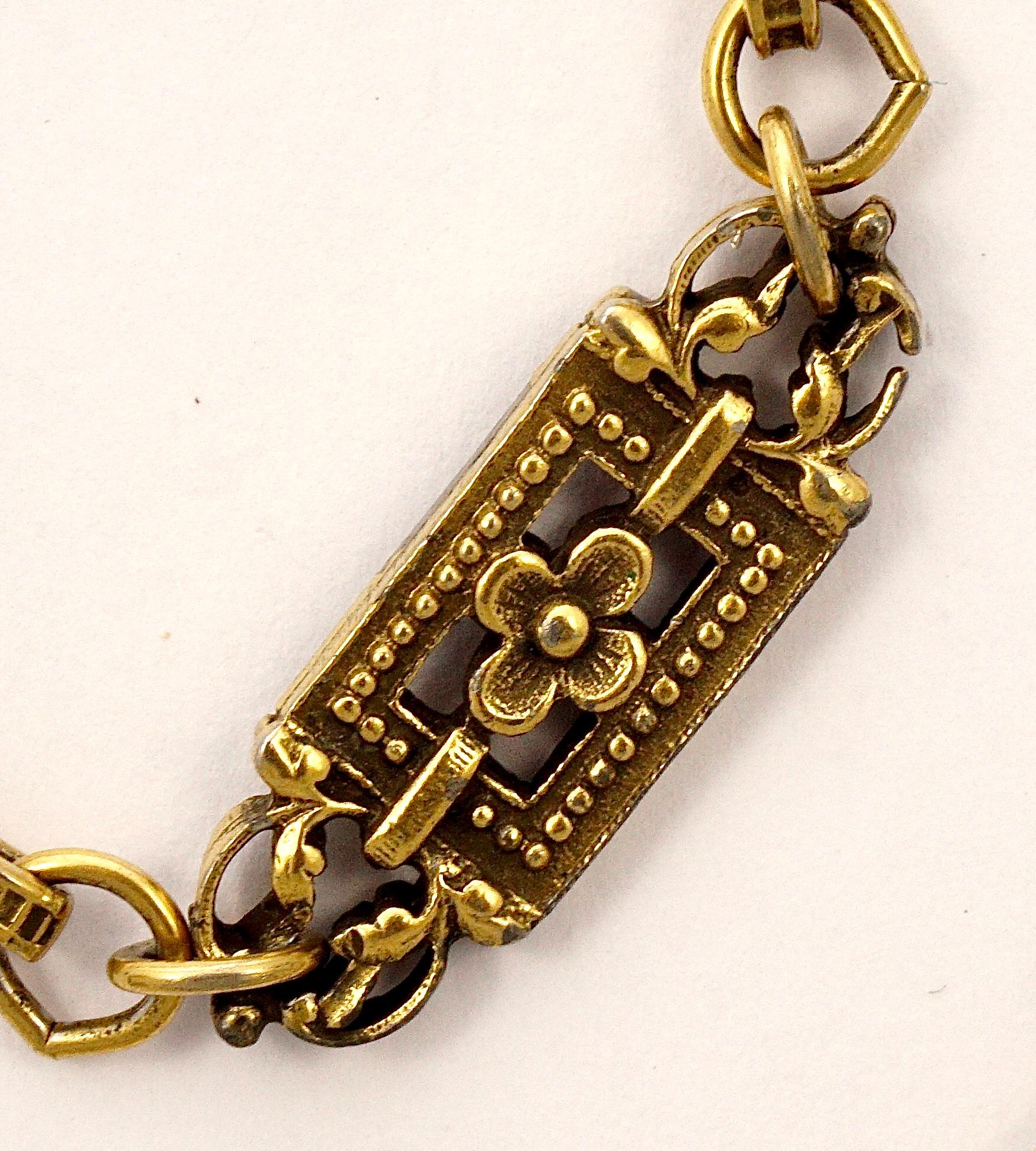 Accessocraft NYC antiqued gold tone necklace featuring Renaissance style flower links. The flowers are linked together by ridged and circle linked design chain. Measuring length 154.5cm / 60.82 inches, and the flower links are length 2.8cm / 1.1