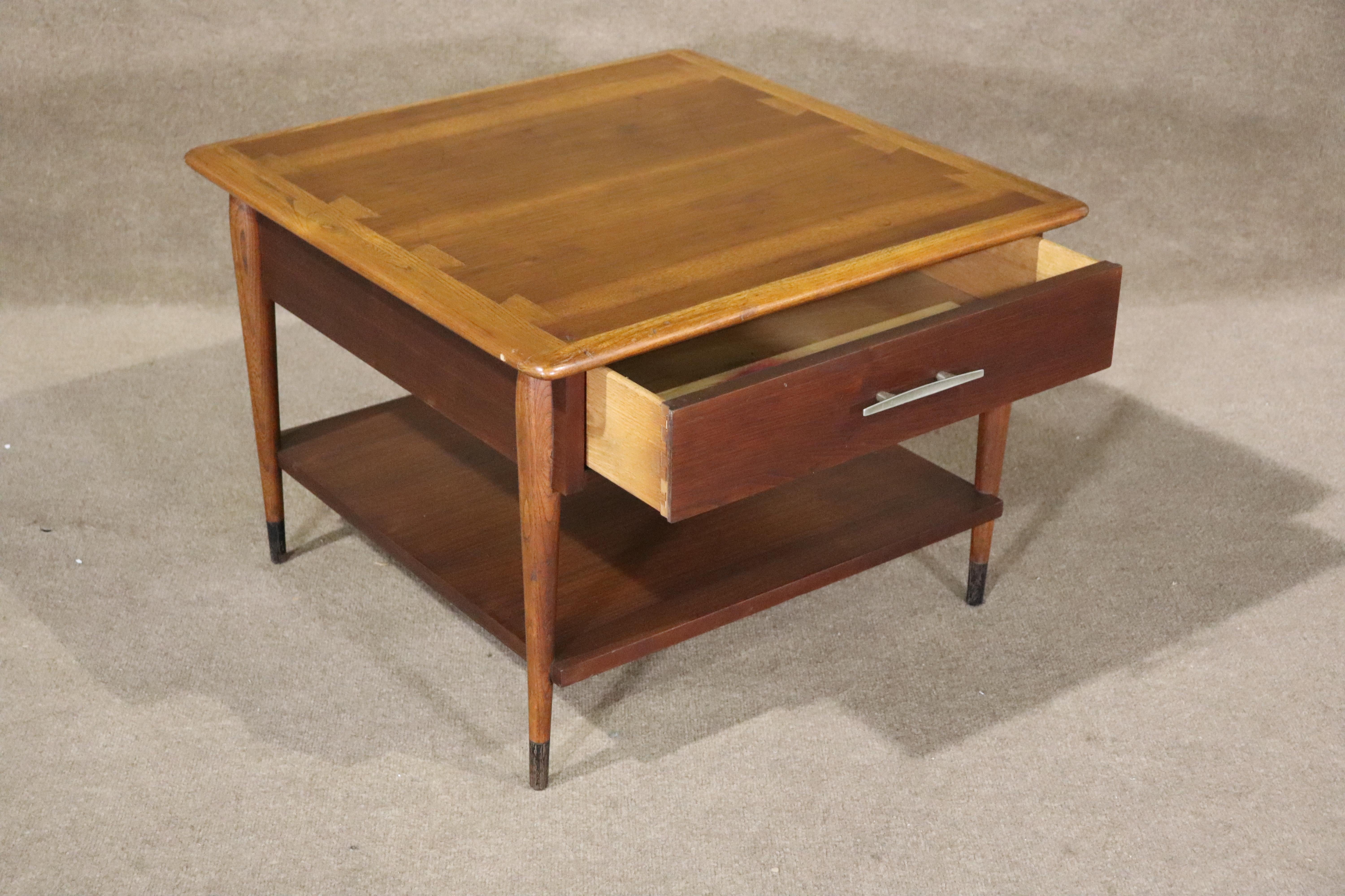 American made end table by Lane Furniture with walnut and oak. Simple mid-century dovetail design with drawer and bottom shelf storage.
Please confirm location NY or NJ