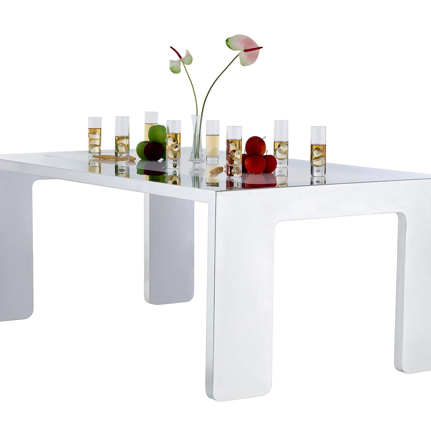 The sharp-lined and essential design of this rectangular table combine the strength of the mirror-finished stainless steel bold legs with the smooth elegance of the white marble top. This exclusive table by Giancarlo Pretazzoli will comfortably sit