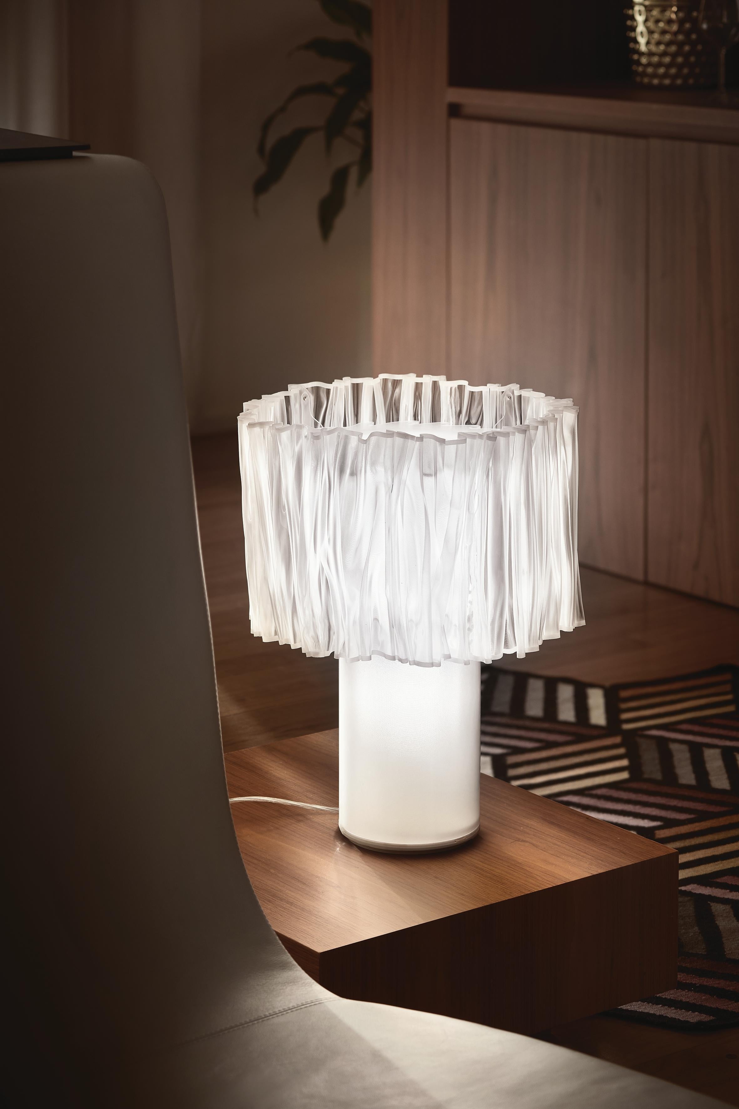 The Accordéon collection represents a new narrative in contemporary design: Slamp's exclusive Lentiflex® material is heated and hand-molded by the women who tailor light. Each piece is one of a kind, but the lamps are identical. A thin steel plaque