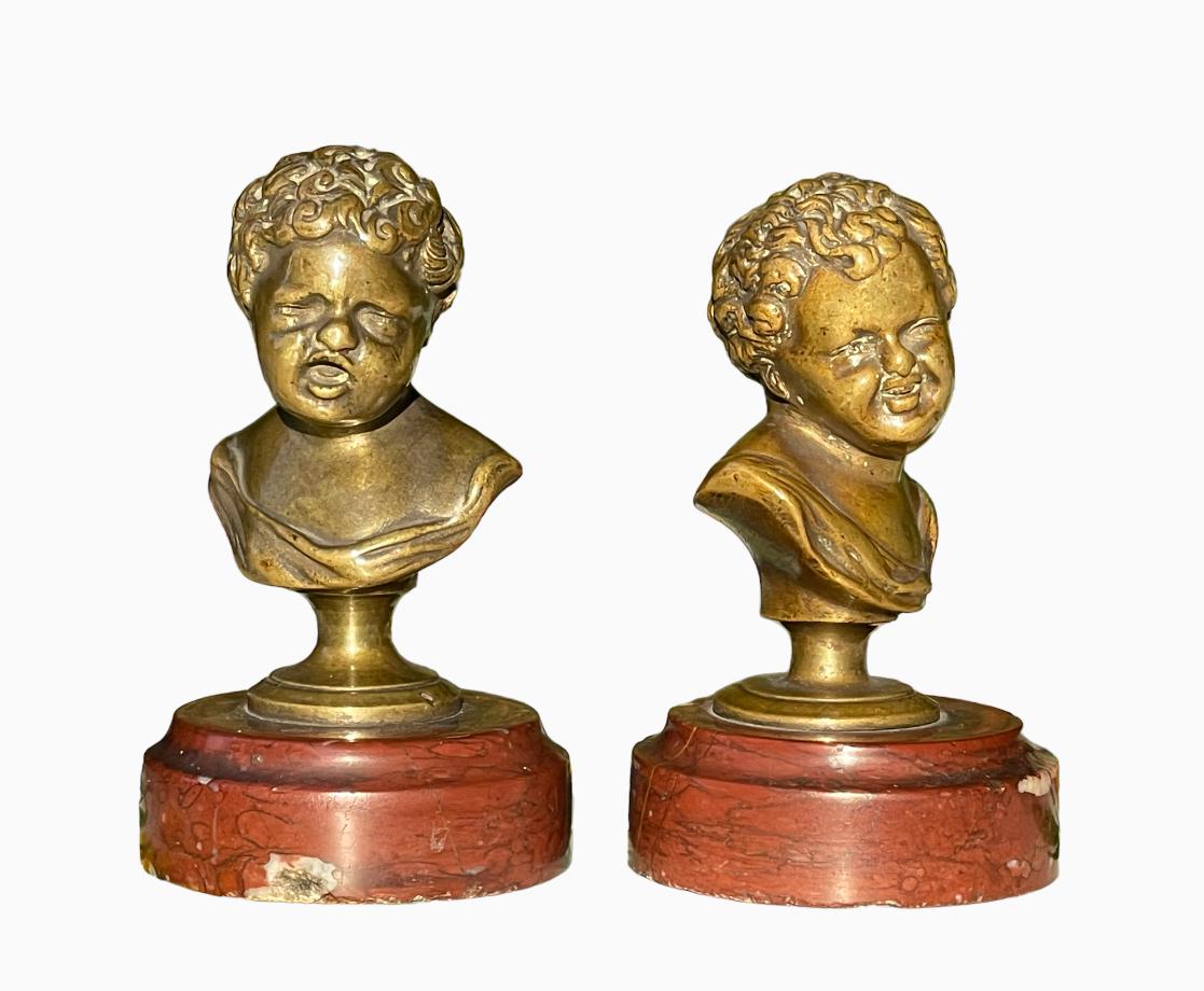 Small bronzes after a model by Houdon representing Jean who laughs and Jean who cries. They rest on a red marble base and are in good condition.

Dimensions
Height 9.5cm