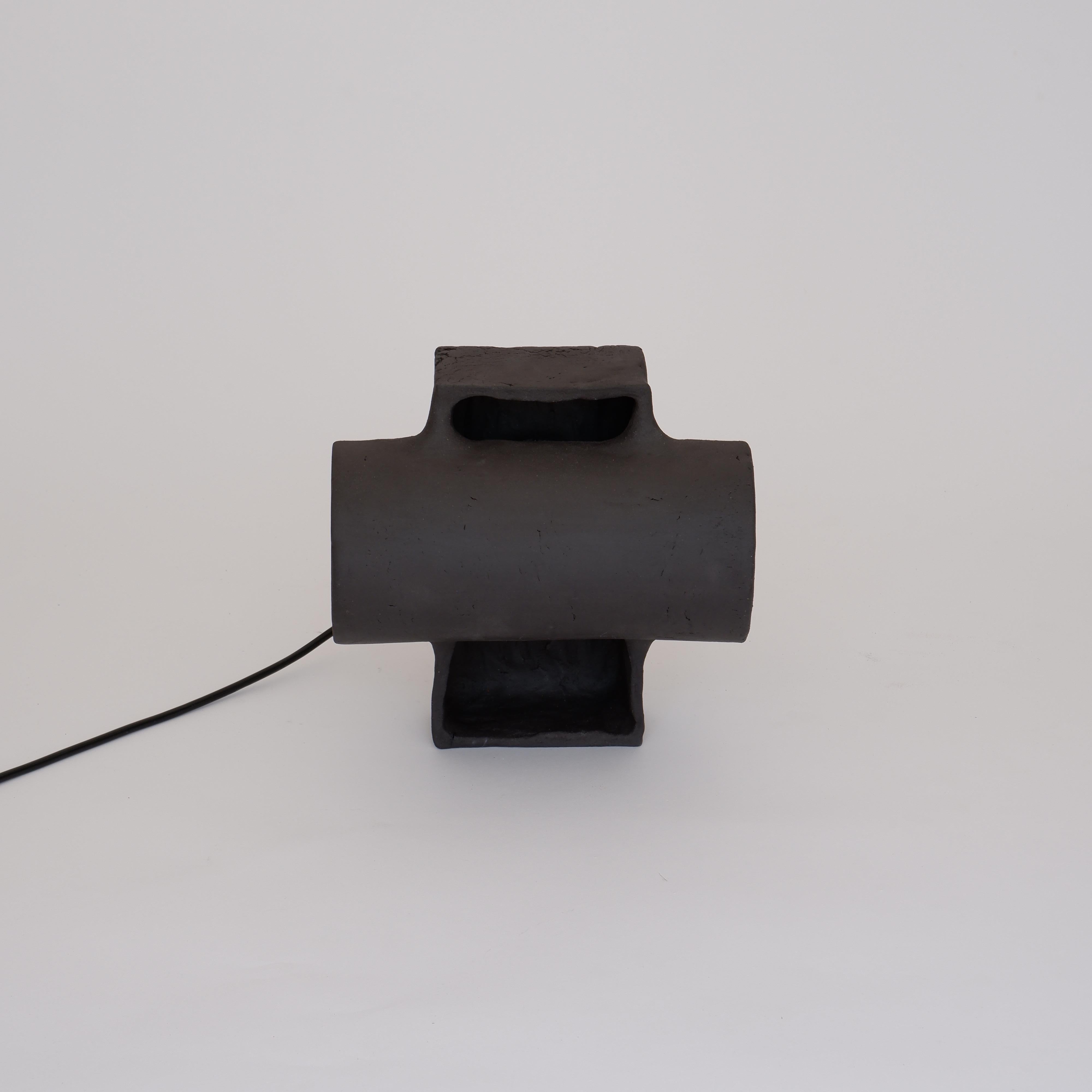 Accre Small Black Lamp by Ia Kutateladze
One Of A Kind.
Dimensions: D 20 x W 23 x H 22 cm.
Materials: Clay.

Each piece is one of a kind, due to its free hand-building process. Different color variations available: raw black clay, raw white clay,