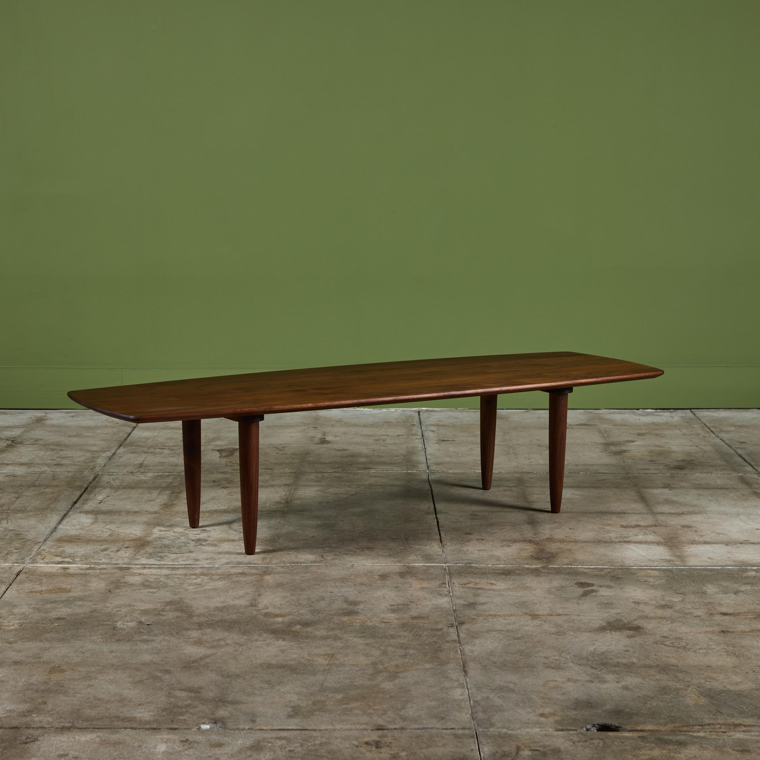 Produced by Ace-Hi of Gardena, California, the Prelude line of furniture features solid walnut construction and simplified (but never reductive) purity of form. This Prelude table has a rounded rectangular shape. The expertly joined walnut wood has