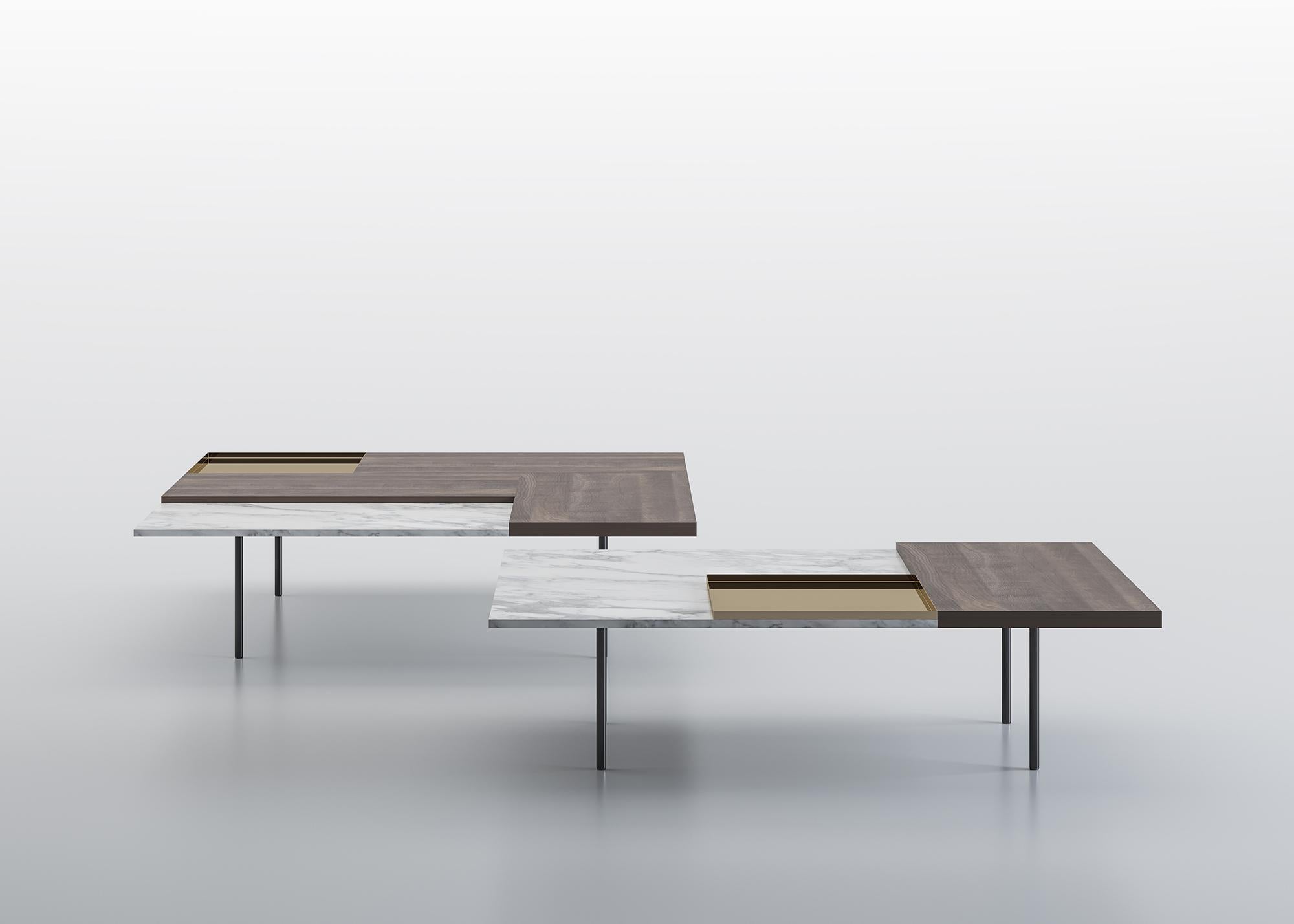A system of small tables with a top made by freely combining different contrasting materials: wood, marble, shiny metals, giving life to a mosaic of materials differing by type, color nuances, texture and thickness. Rectangular or square, the tables