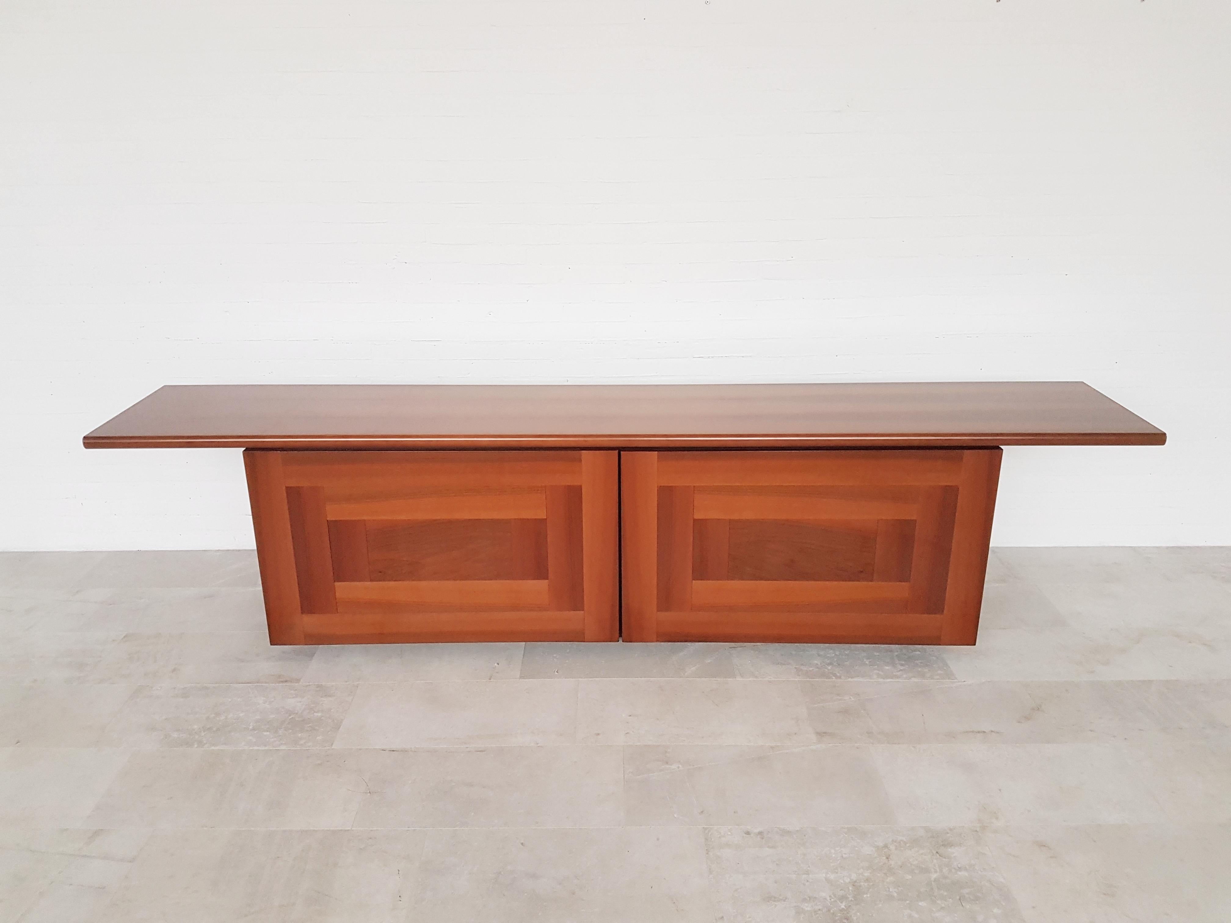 Post-modern credenza titled “Sheraton”, a design by Giotto Stoppino and Lodovico Acerbis for Acerbis International. 
A very wide top in glossy cherry; two sliding doors hide plenty storage possibilities and also open up completely.
Winner of the