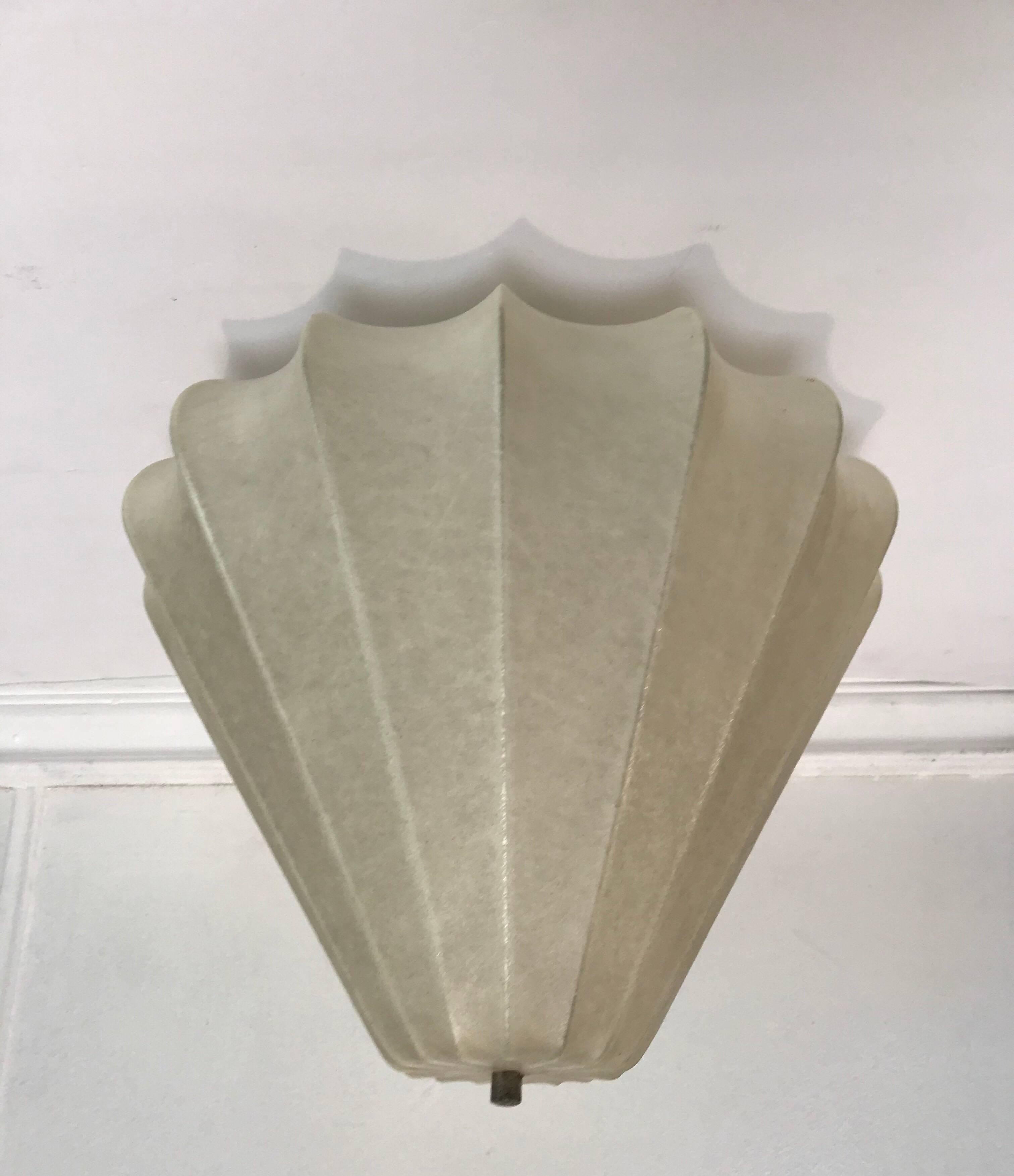An Italian sculptural ceiling light designed by Achille Castiglioni for Flos in the 1960s. A spun resin shade with a brass fitting. It can be dropped on a ceiling pole of hung with a cord to be used as a pendant. Newly Rewired. Standard 120 watt