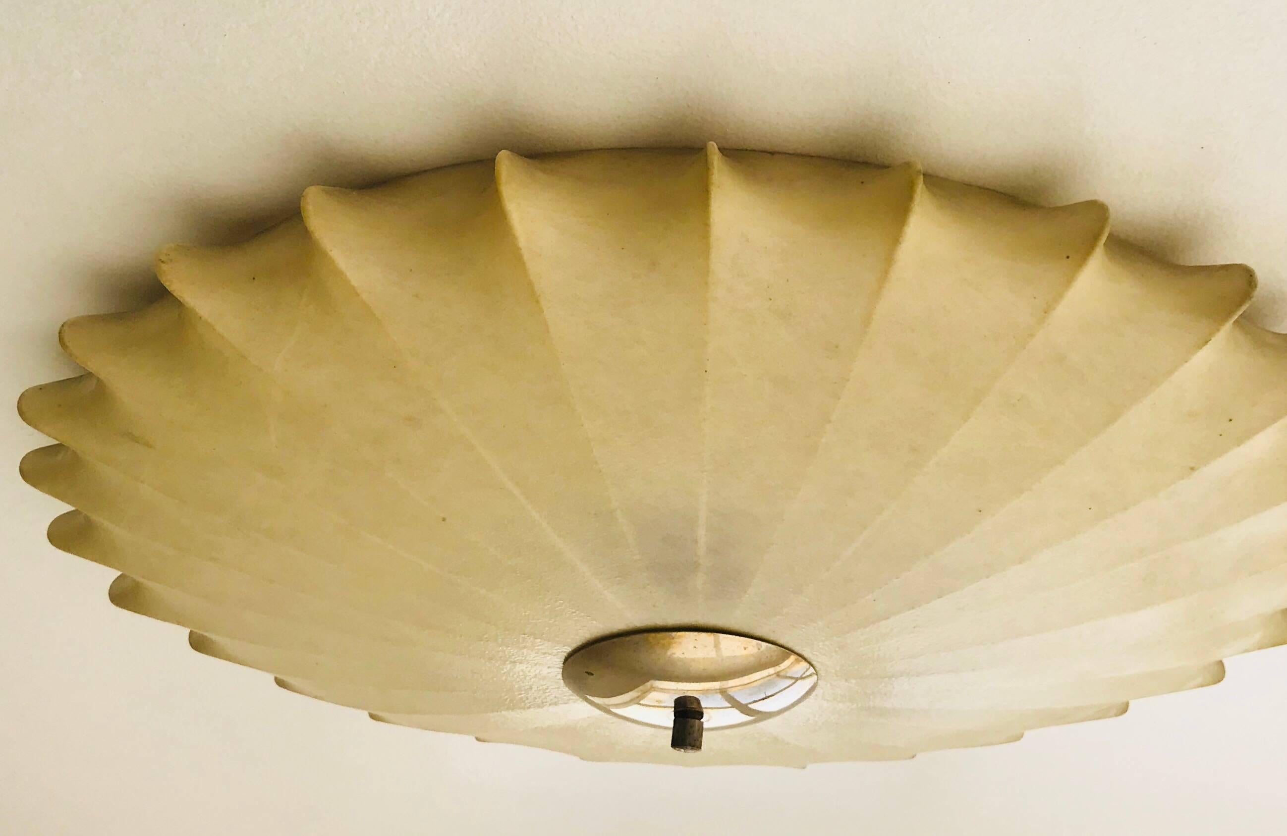 A large sculptural 1960s flush ceiling light designed by Achille Castiglioni for Flos, 1960s . It composed of a spin resin shade with a polished brass fitting and finial. Five candelabra sockets and newly Rewired. 