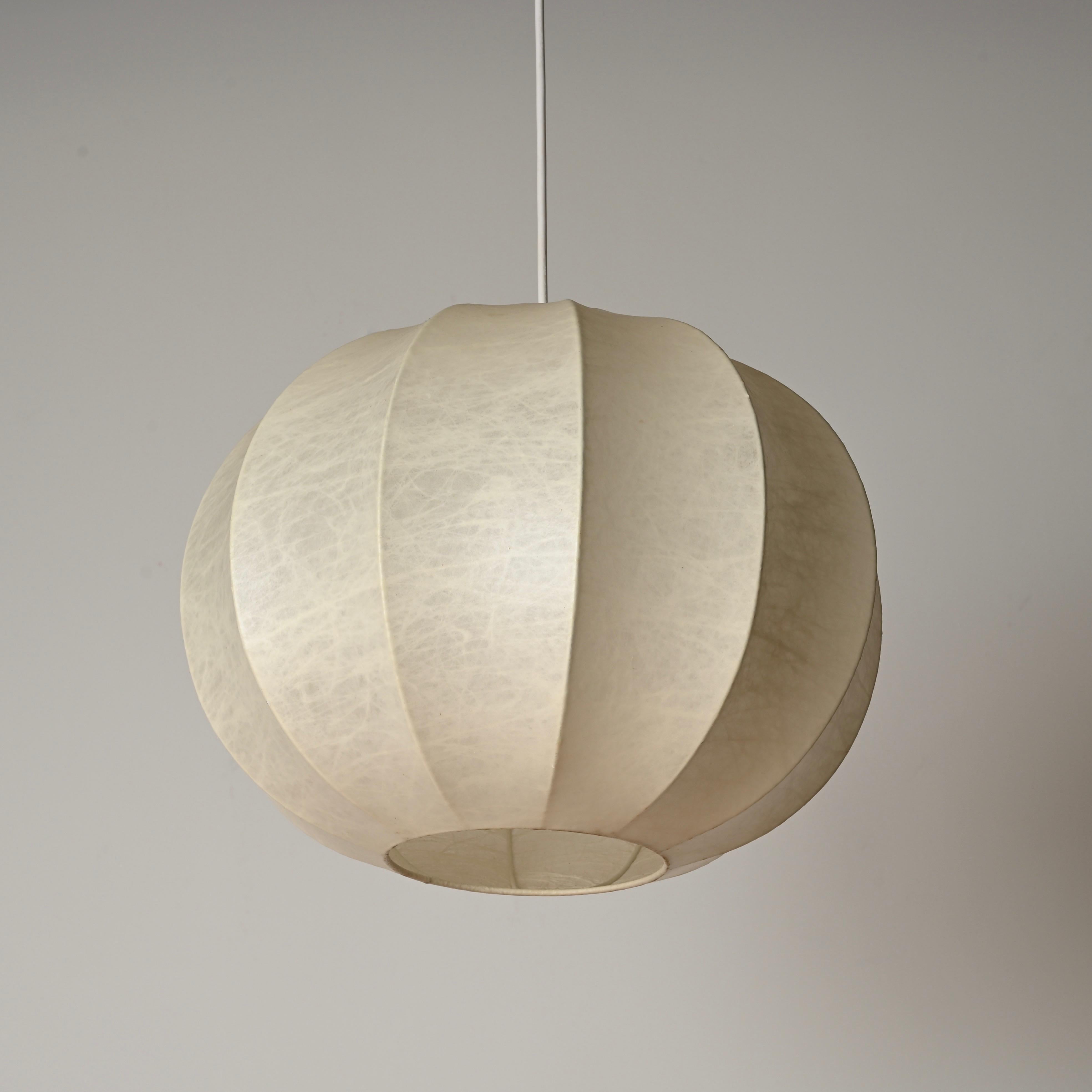 Stunning mid-century beige cocoon pendant in resin and steel. This gorgeous cocoon ceiling lamp was designed by Achille Castiglioni in Italy during the 1960s.

This cocoon has a marvelous vintage beige patina that makes it incredibly charming and