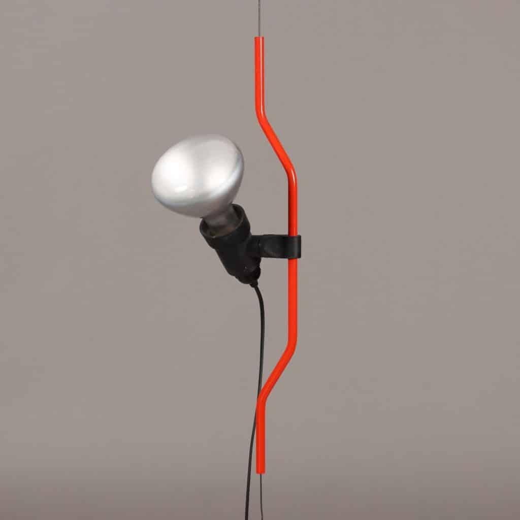 Iconic floor-ceiling lamp model 'Parentesi' designed by Achille Castiglioni and Pio Manzù, produced by Flos. Height-adjustable and directional point of light by sliding a shaped, red-lacquered steel tubing over a steel cable stretched between