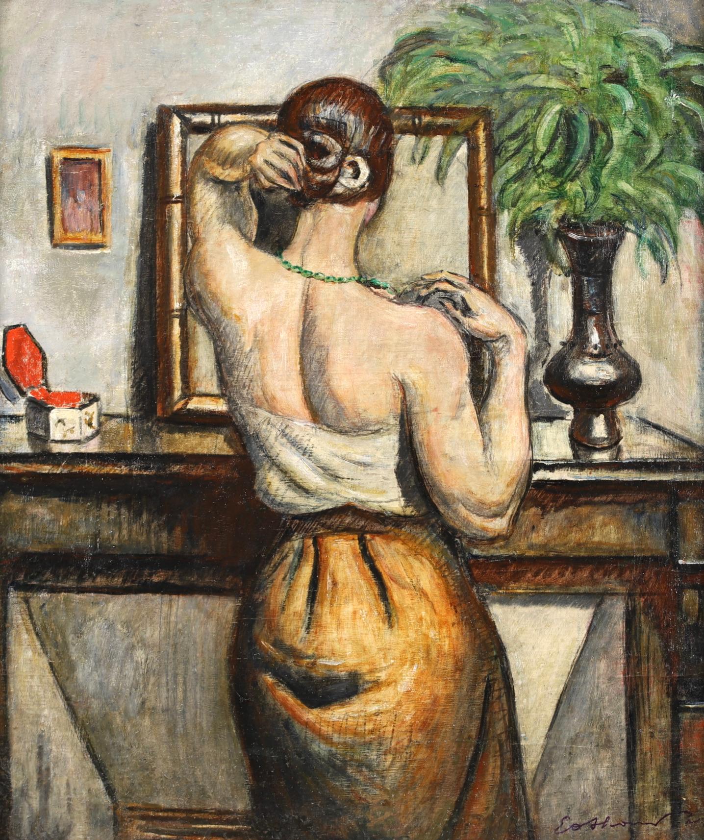 Signed figure in interior oil on canvas circa 1920 by French post impressionist painter Achille-Emile Othon Friesz. The piece depicts a woman standing at a dressing table doing her hair as she looks in the mirror. There's an open trinket box to her