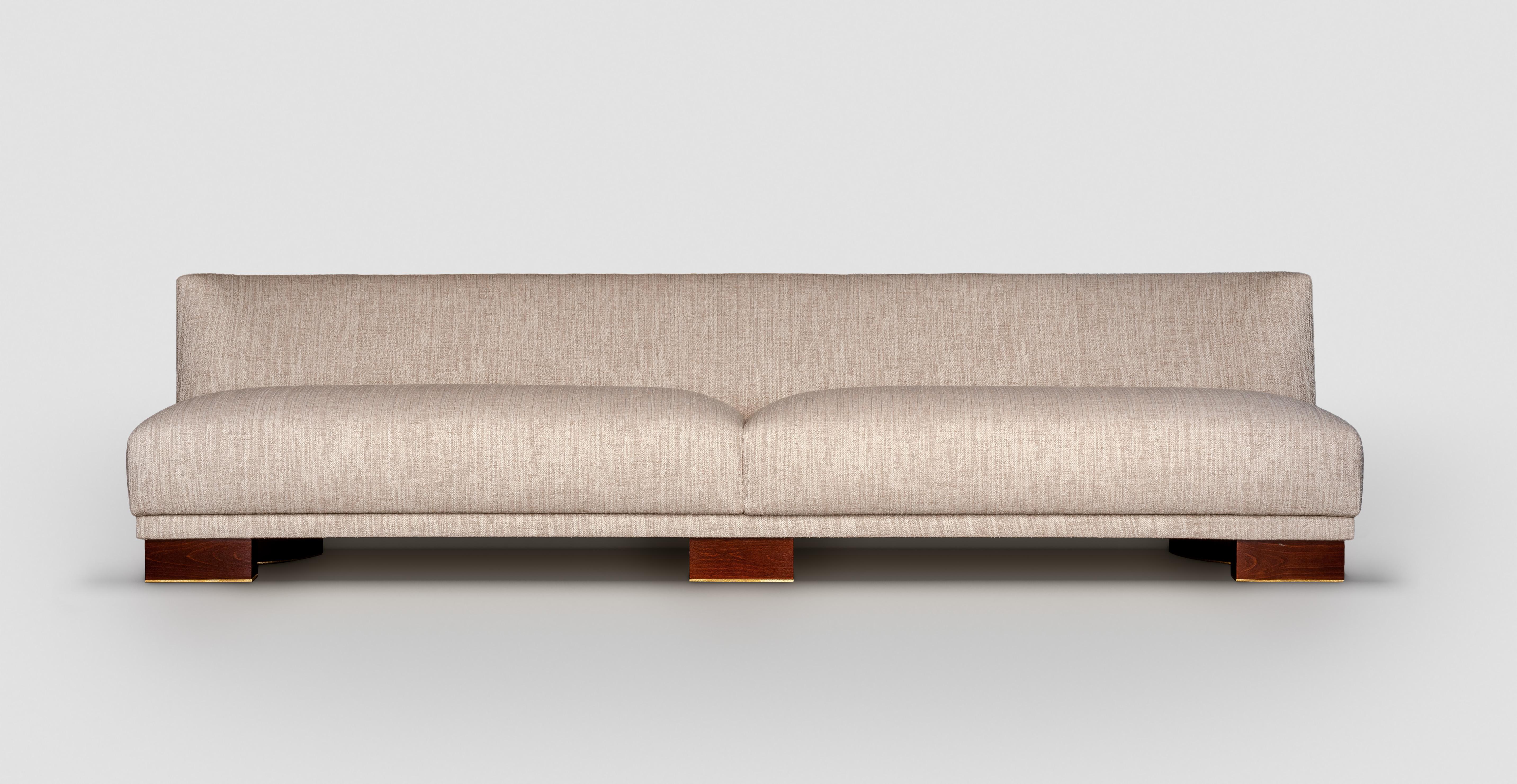 Achille Salvagni
Alcyone
2019
Upholstered sofa with a gentle sweeping curved side, made of a polished walnut wood structure and polished 24-carat gold-plated hand-engraved brass details.  The base offers a discrete flash of bronze and lacquer.  Sold
