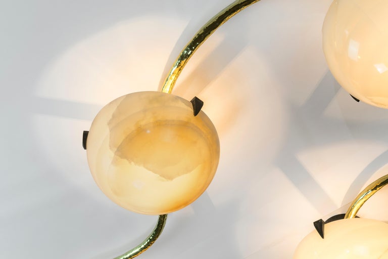 Achille Salvagni
Leros
2016
Back-lit hand carved onyx lamps; can be installed as a flush mounted ceiling chandelier or as a wall mounted sconce. This work features a burnished cast bronze structure and hand-engraved brass clasps. Inspired by a trip