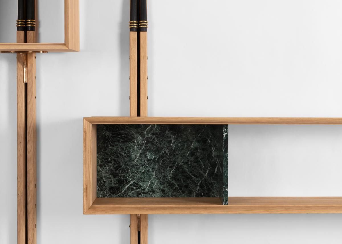 Masai is an elegant wall-mounted presentation unit made of sanded walnut with bronze details. Shelf and box elements adorned with marble can be mounted anywhere along the vertical lengths to customize display.

Dimensions vary depending upon