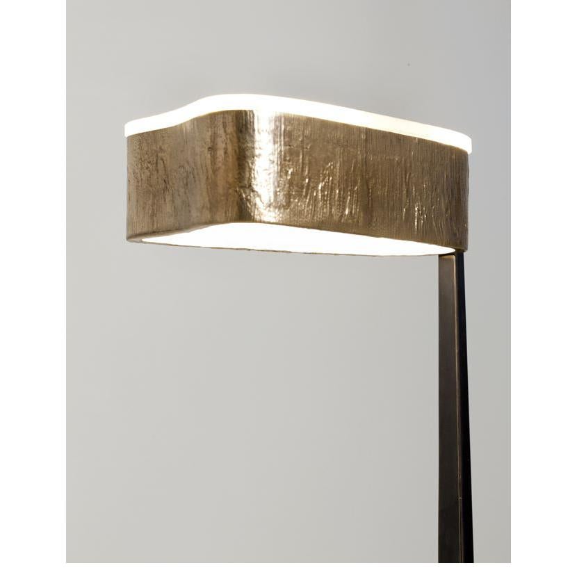 A floor lamp in gunmetal bronze, accented with shades of polished bronze and onyx.
