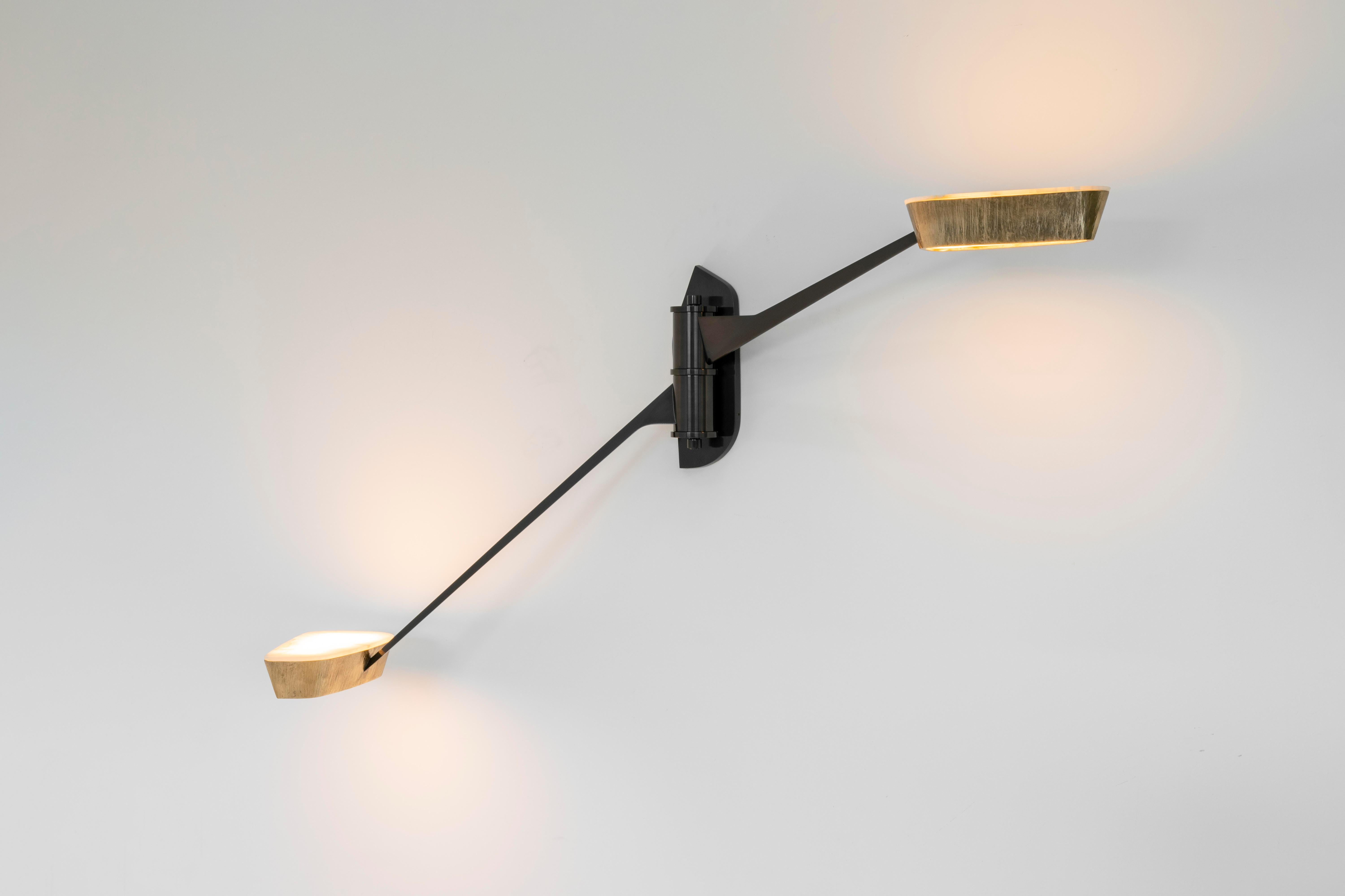 Vatulele, a two arm sconce in the vein of Salvagni's wildly popular Spider, features a pair gunmetal patinated bronze arms, accented at their ends with shades of polished bronze and onyx. The two reach out, each at its own height, and swivel,