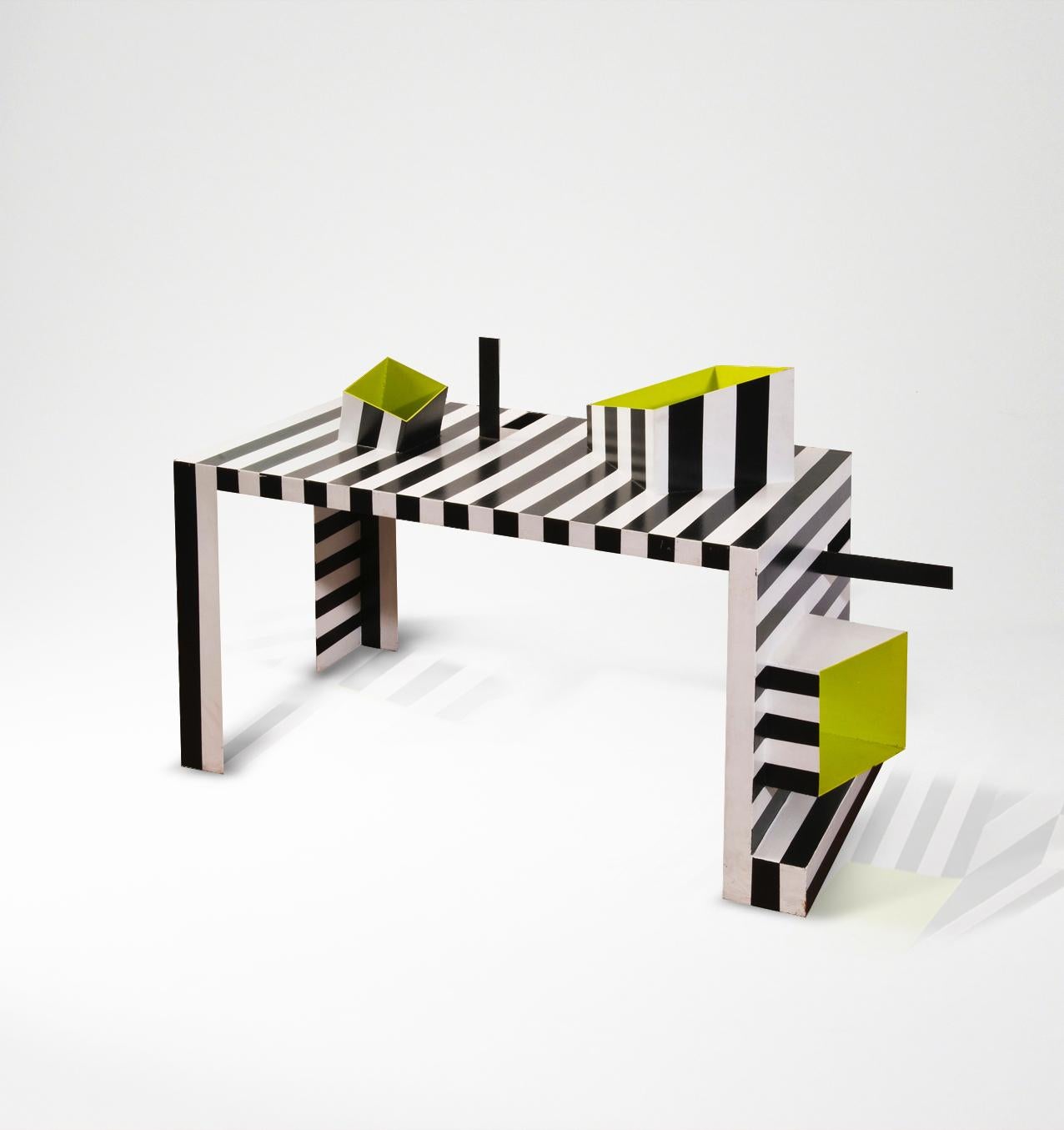 For Studio Alchimia, by Alessandro Guerriero
Painted and cut steel, in dramatic black and white stripes. Asymmetrical 'boxes' (the interiors brightened in lime green paint) protrude from desk top and side for organising paperwork, desk accessories,