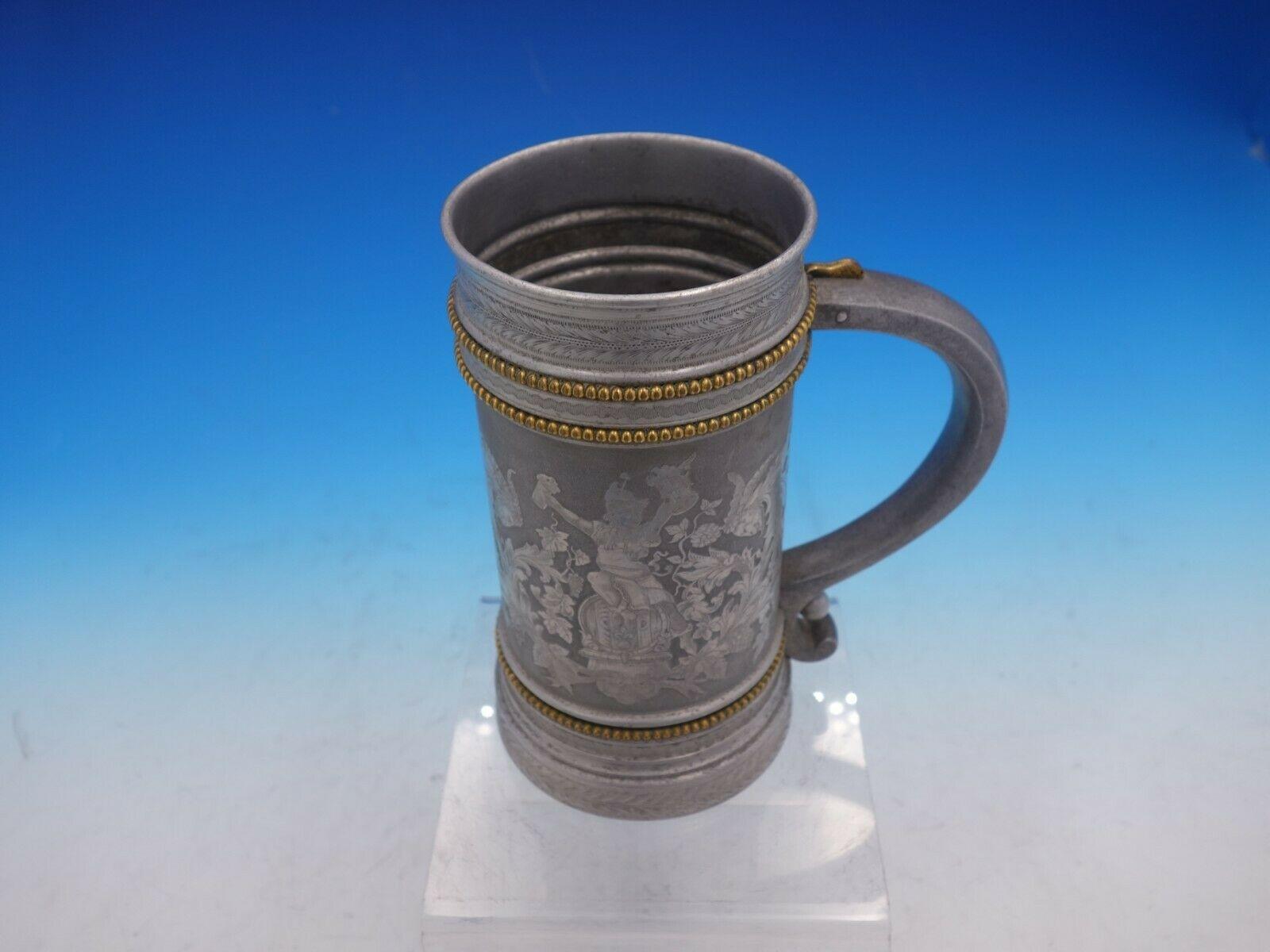 Gorham

Mixed metals by Gorham mug rave aluminum with applied bronze beading, acid etched man on wood barrel holding a mug in each hand, acid etched hops, and acid etched grapes marked #11. It measures 6 1/2
