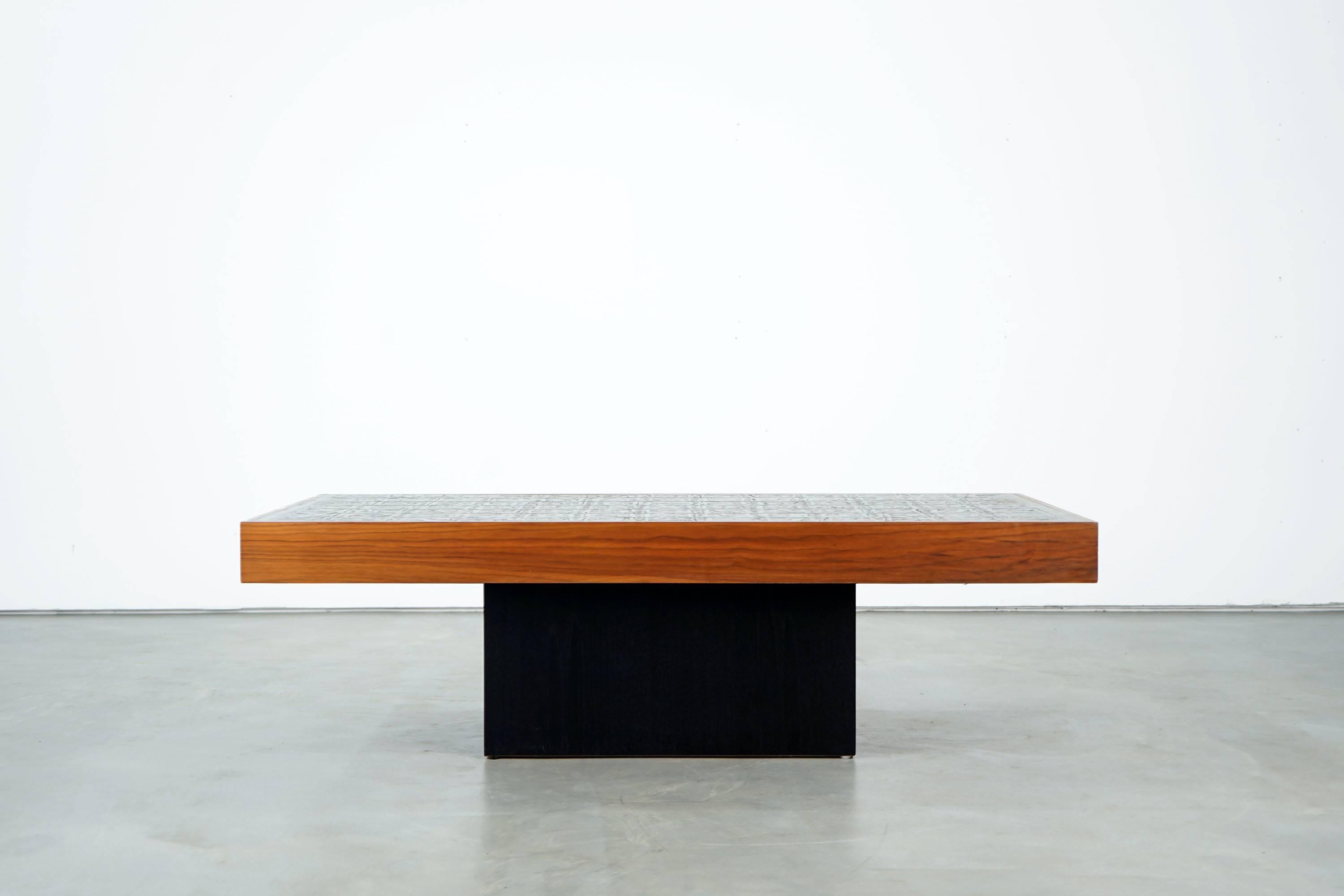 Decorative zinc sofa table with acid etching, designed, circa 1970 by Bernhard Rohne. The tabletop rests on a black wooden frame. The object is in a very good condition.