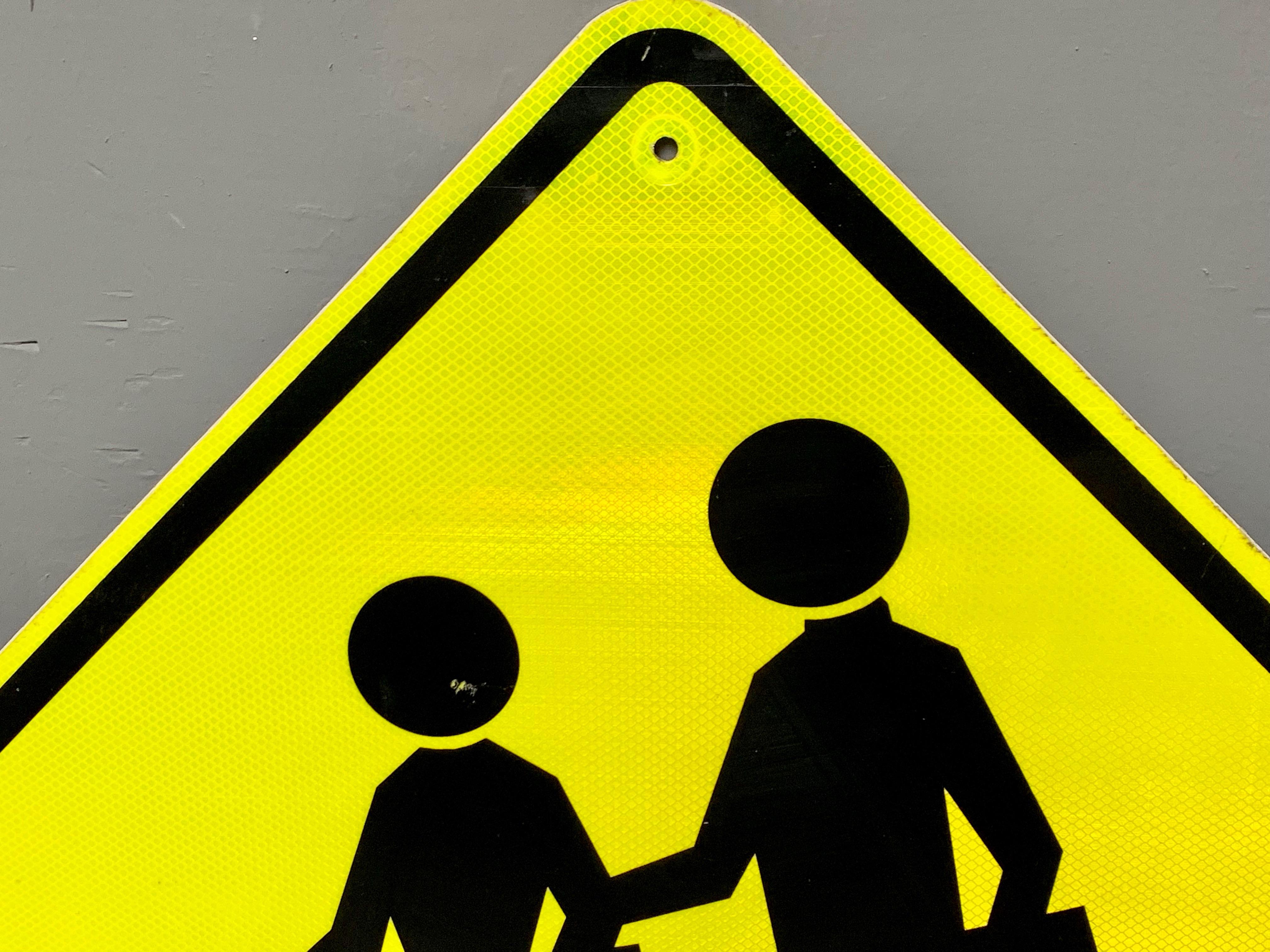 yellow person walking sign