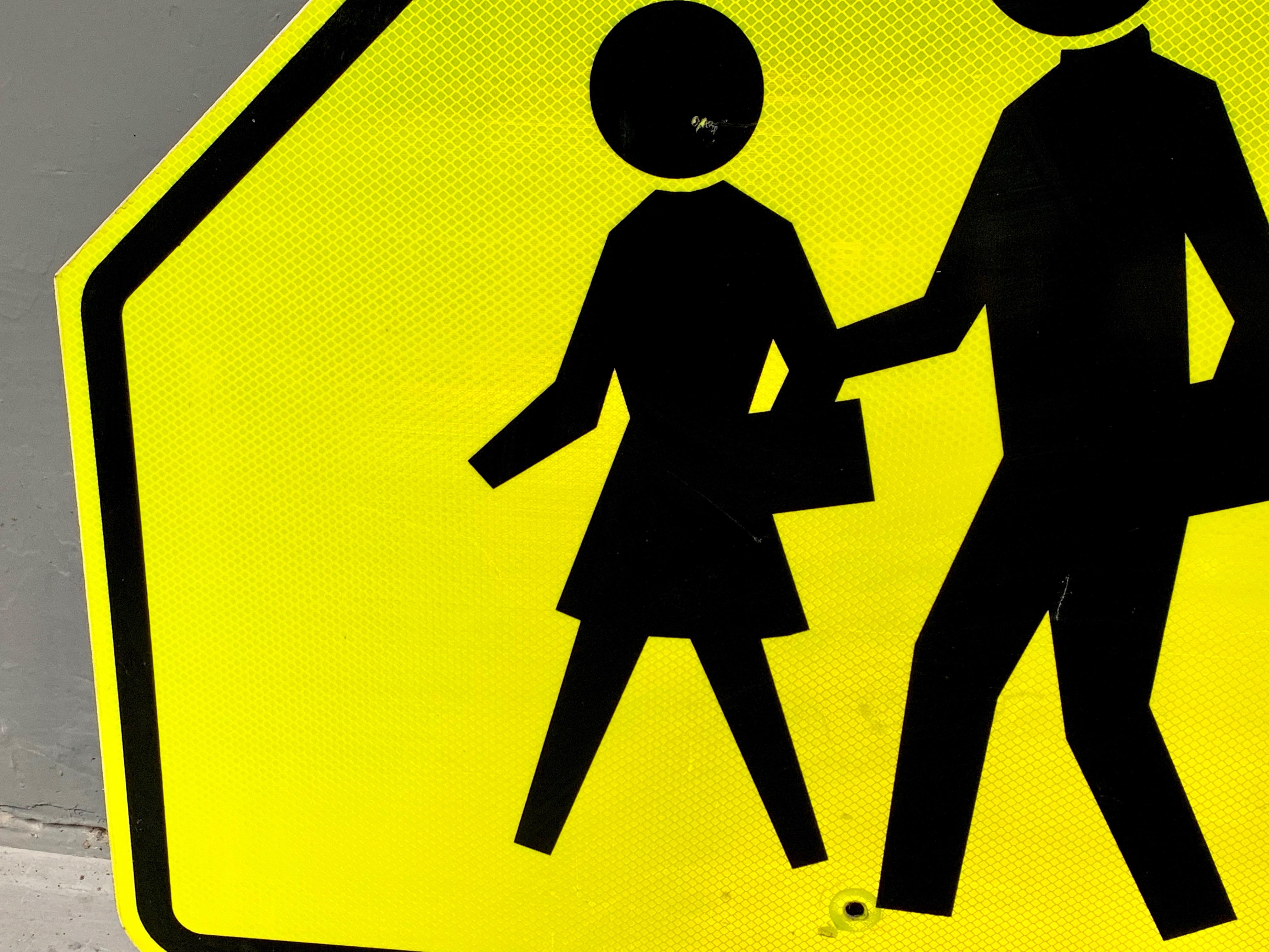 yellow sign with person walking