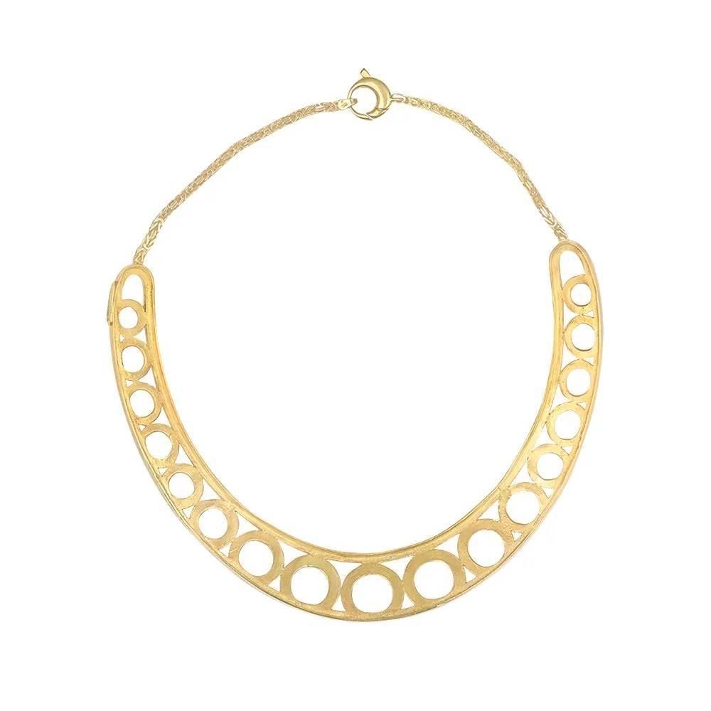 This collar necklace, designed by A. Cipullo, showcases an elegant geometric design. Handcrafted in luxurious 18k yellow gold, it lies flat against the collarbone, suspended by a chain of interlocking links. The signature 