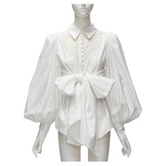 ACLER camicetta con maniche a sbuffo in cotone bianco con ritaglio di occhielli e grande fiocco US2 S. White