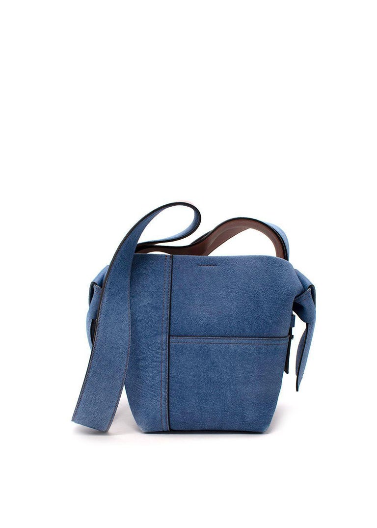 Acne Studios Denim Blue Mini Patchwork Musubi Bag

- Signature bucket style bag, with knotted flap strap
- Tan leather interior, with mock denim textile exterior including jean-style stitching
-Silver-tone hardware
- Internal zip-fastening