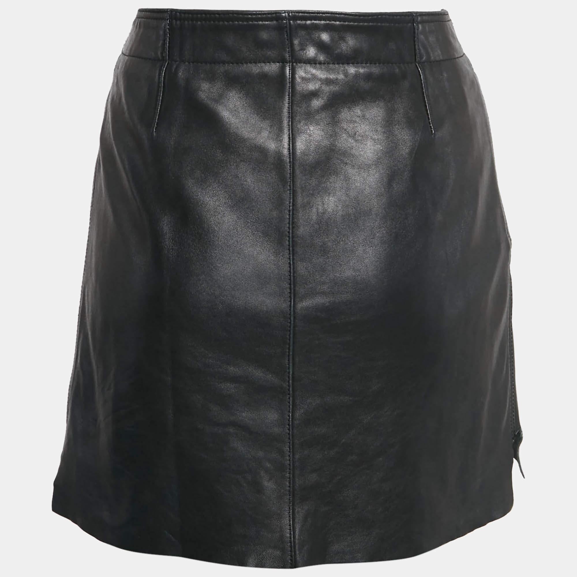 The Acne Studios skirt combines edgy style with sophistication. Crafted from high quality black leather this mini skirt features a wrap design adorned with silver tone studs adding a bold touch. Its sleek silhouette and minimalistic aesthetic make