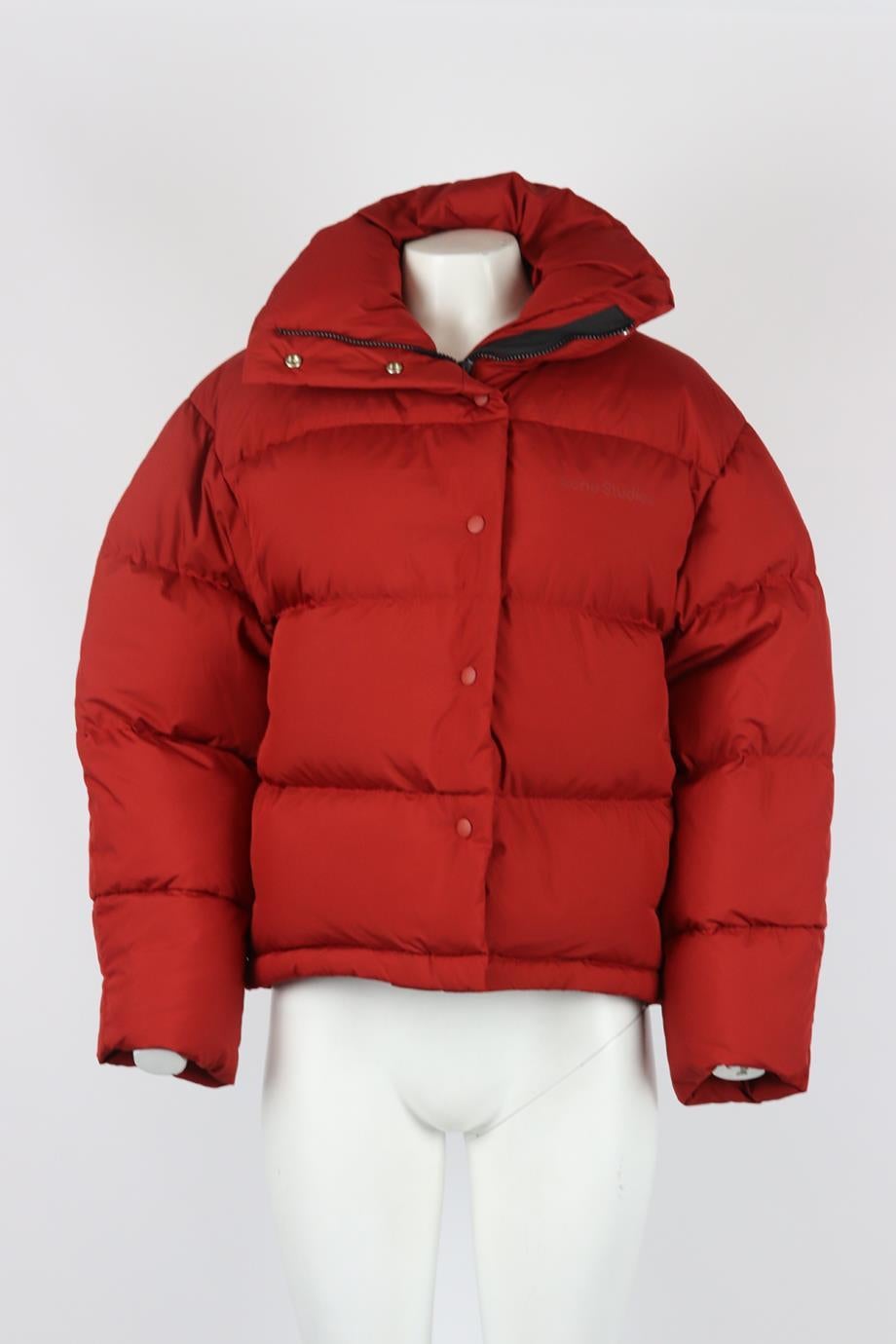 Acne Studios quilted shell down jacket. Red. Long sleeve, turtleneck. Zip fastening at the front. 100% Polyester; lining: 100% nylon; padding: 90% duck down, 10% duck feathers. Size: XSmall (UK 6, US 2, FR 34, IT 38). Shoulder to shoulder: 20.5 in.