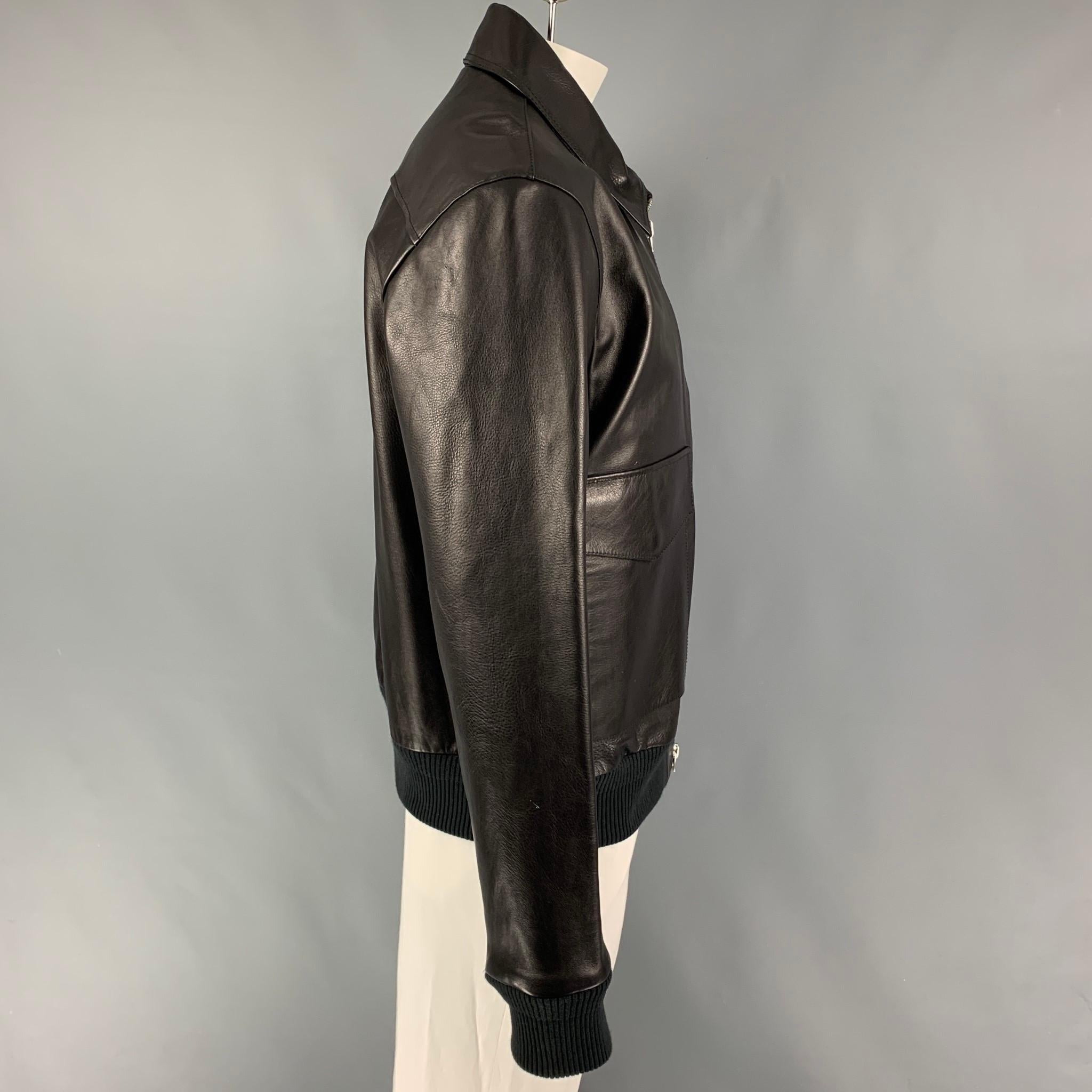 ACNE STUDIOS jacket comes in a black leather featuring a bomber style, ribbed hem, patch pockets, spread collar, and a full zip up closure. 

Very Good Pre-Owned Condition.
Marked: 54
Original Retail Price: $1,300.00

Measurements:

Shoulder: 21