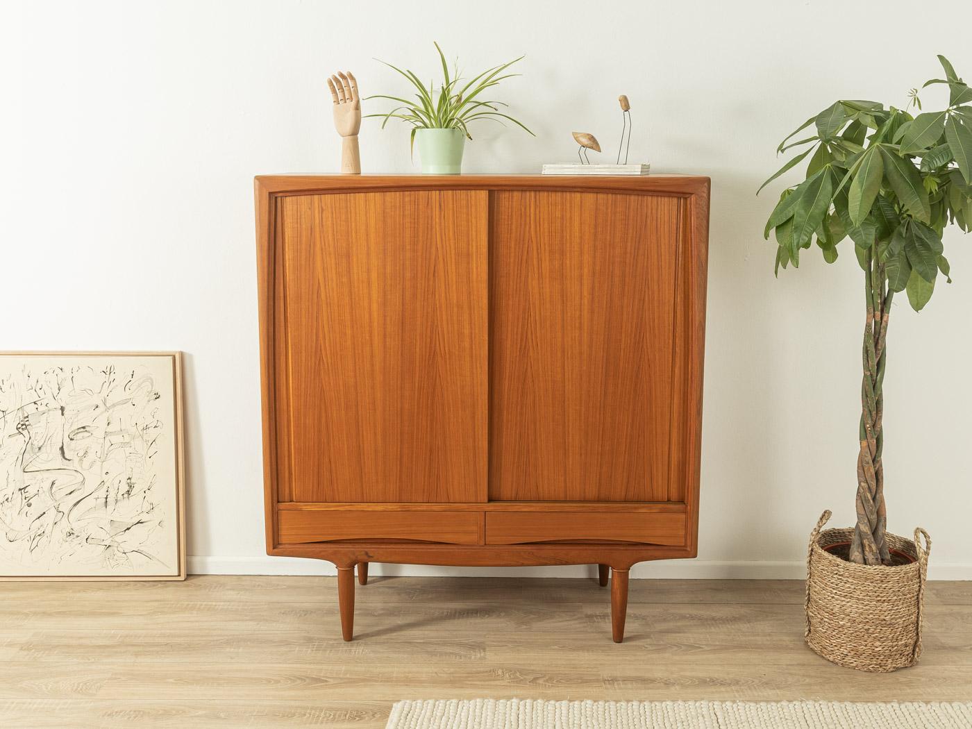 Wonderful highboard from the 1960s. High-quality corpus in teak veneer with two drawers, two sliding doors, three shelves, five internal drawers and cigar shaped feet.

Quality features:
- accomplished design: perfect proportions and visible