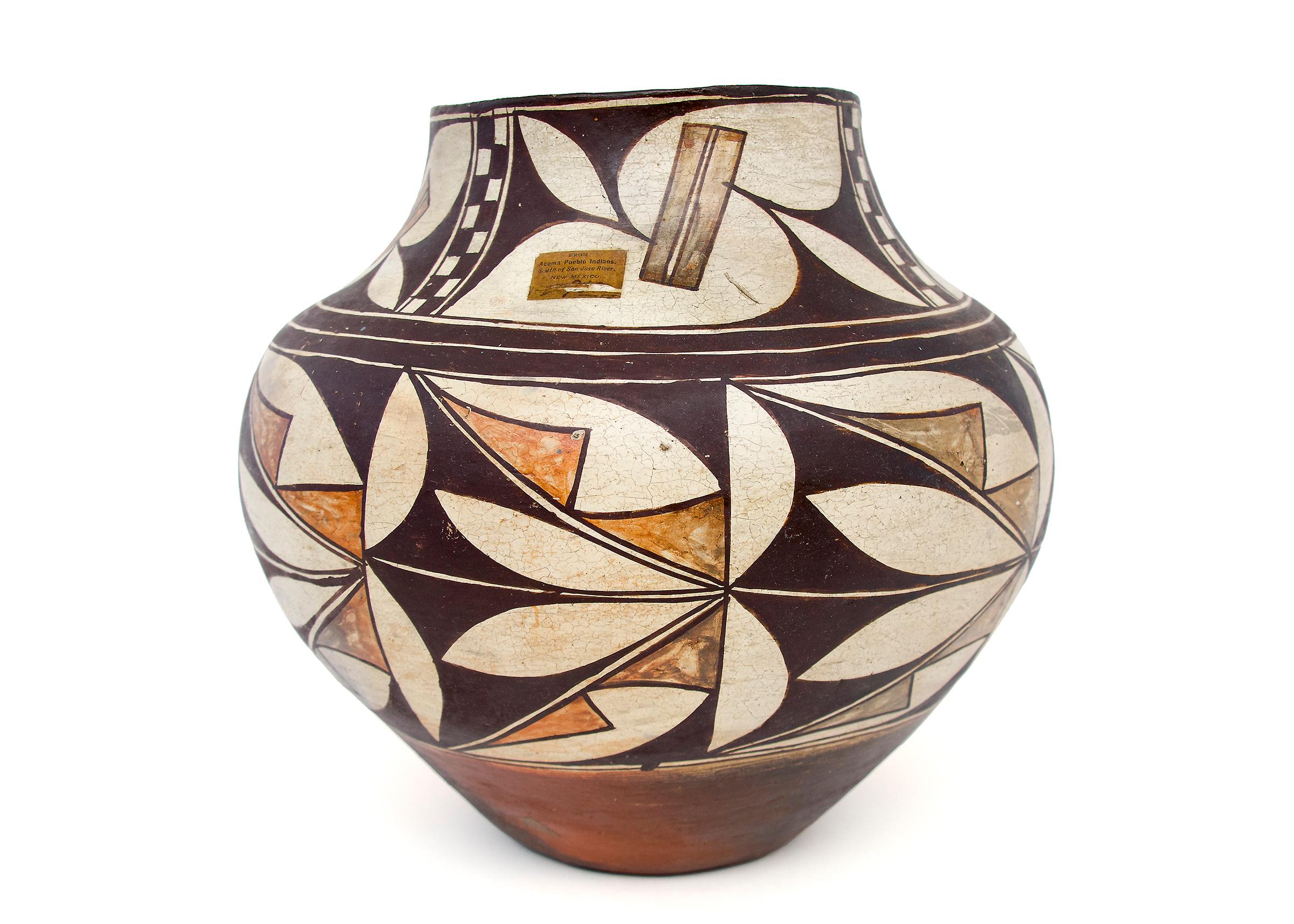 Acoma Olla (storage jar), Polychrome with abstract foliate motif. Earthenware with slip glazes, dimensions measure 11 ½ inches tall and 11 inches diameter.

An earthenware Jar constructed by hand and painted with slip glazes in an intricate design