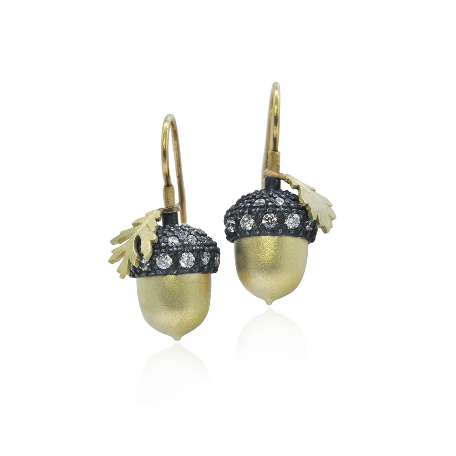 An homage to the mighty oak tree, these stunning earrings feature a duo of silver and gold acorns with diamond encrusted tops. Beautifully crafted acorns in 18k yellow gold, oxidized silver and pave set diamond top. 18ky wires. the perfect accent