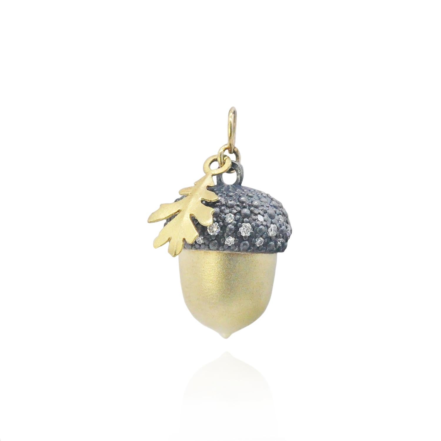 Two beautifully crafted 18k yellow gold and oxidized silver acorns sprinkled with pave set diamonds dangle from the ends of this gorgeous lariat necklace. 18k yellow gold oak leaves flutter down the 36