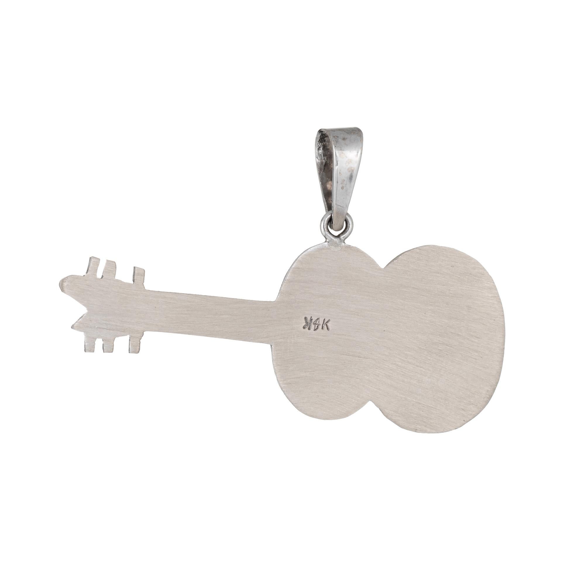Finely detailed acoustic guitar pendant crafted in 14k white gold.  

The nicely detailed pendant features etched detail that realistically depicts an acoustic guitar.    

The pendant is in excellent original condition and was recently