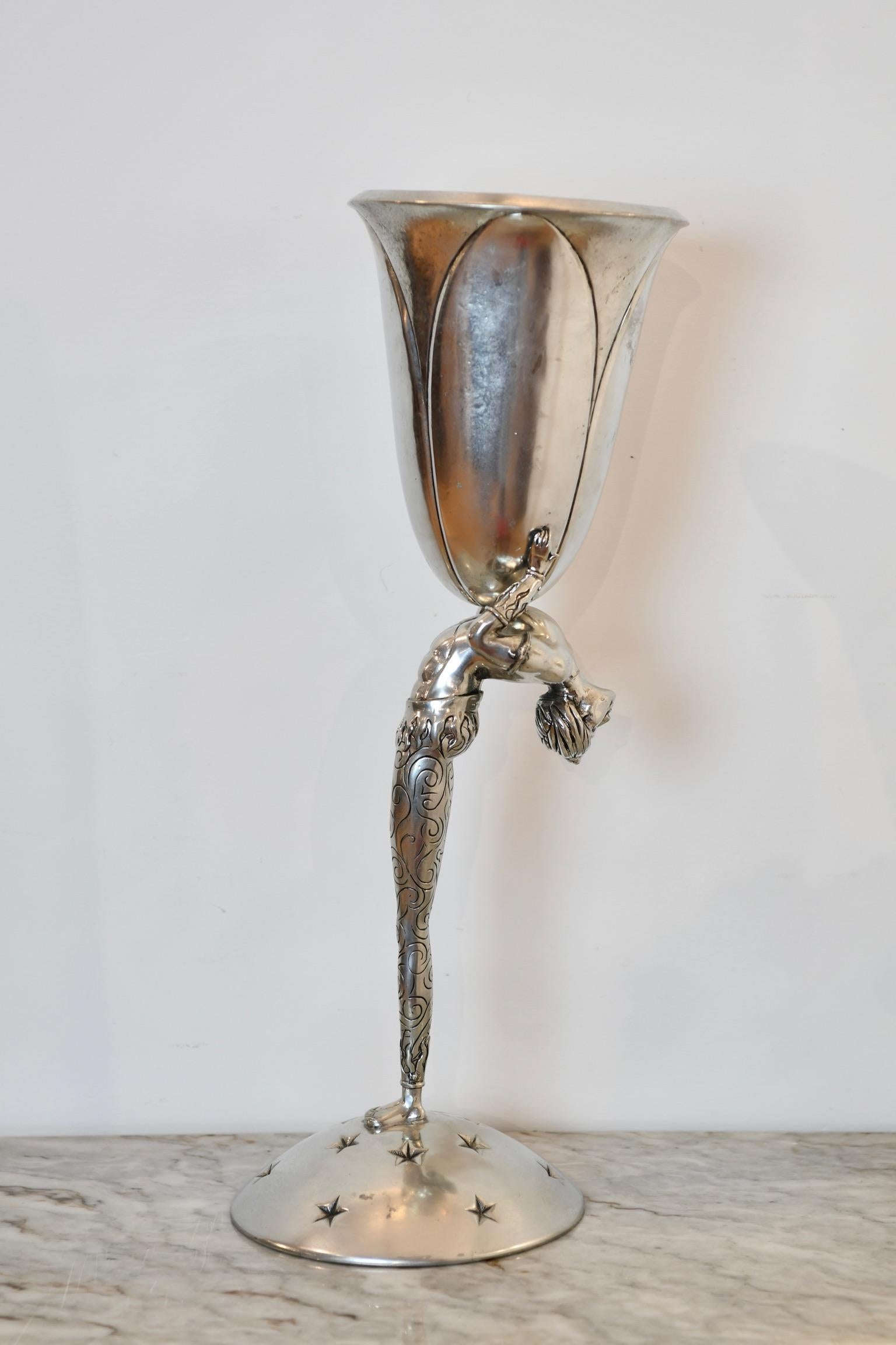 Pewter vase with acrobat arched back holding centerpiece vase and on star accented domed base. Marked to base Piero Figura for Atena, Milan. Dimensions: 24.5