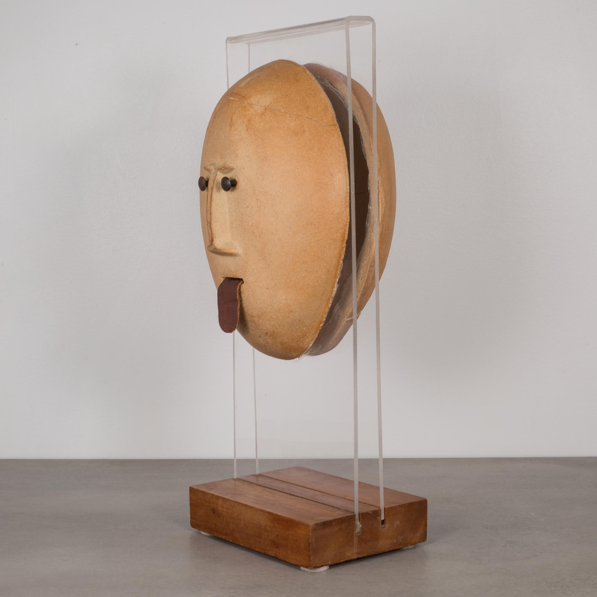 About

The is an original sculpture by David Gil for Bennington Potters. A mid-century ceramic head with burnished screw eyes and leather tongue mounted on Lucite and a wooden base. Stamped in the back 
