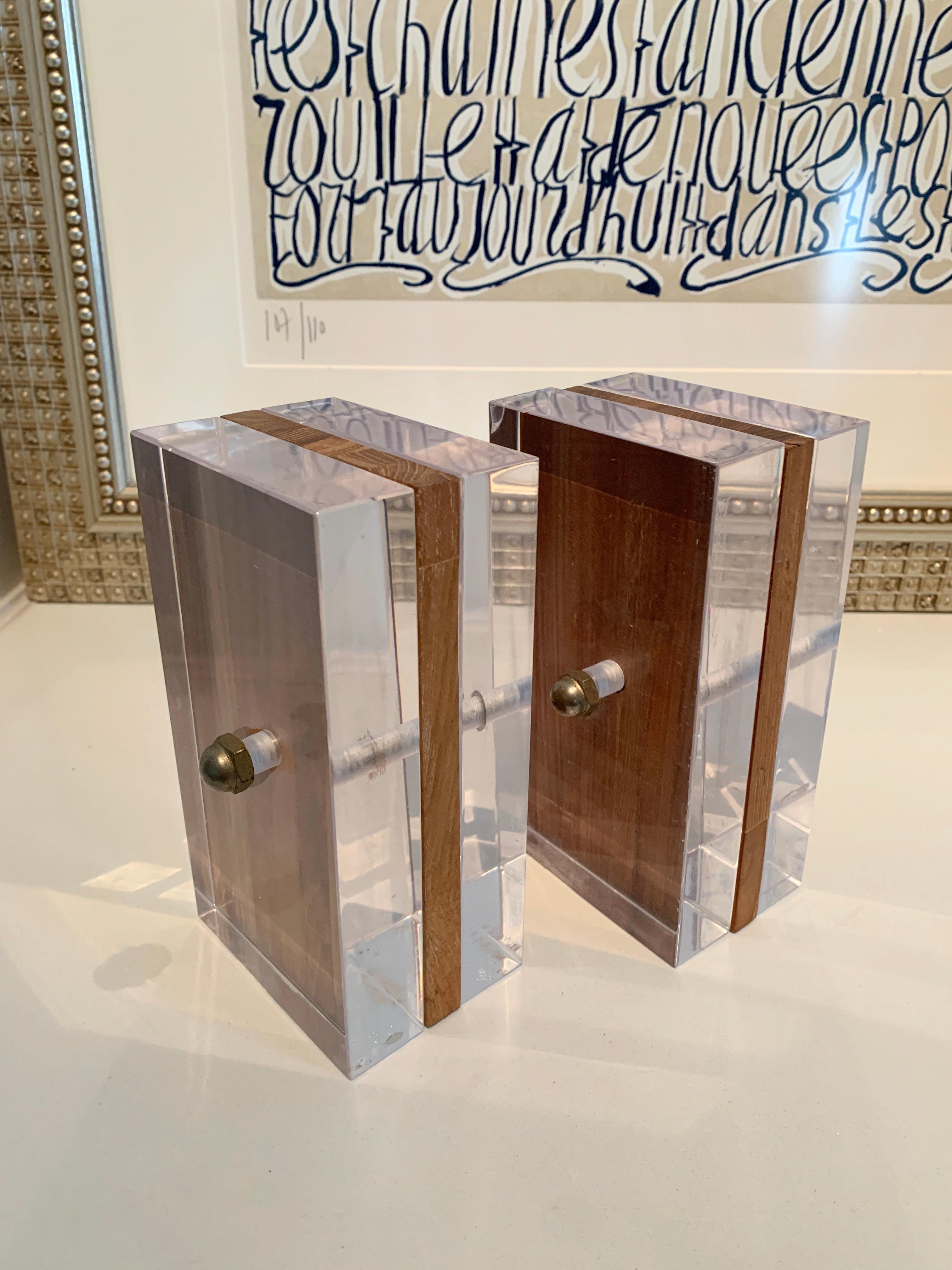 A versatile pair of Ritts for Astrolite Bookends. Whether your den or library is modern or in a paneled room, this pair has you covered. The bolts on either side add an industrial touch. Made by the Ritts Company. Renowned photographer, Herb Ritts