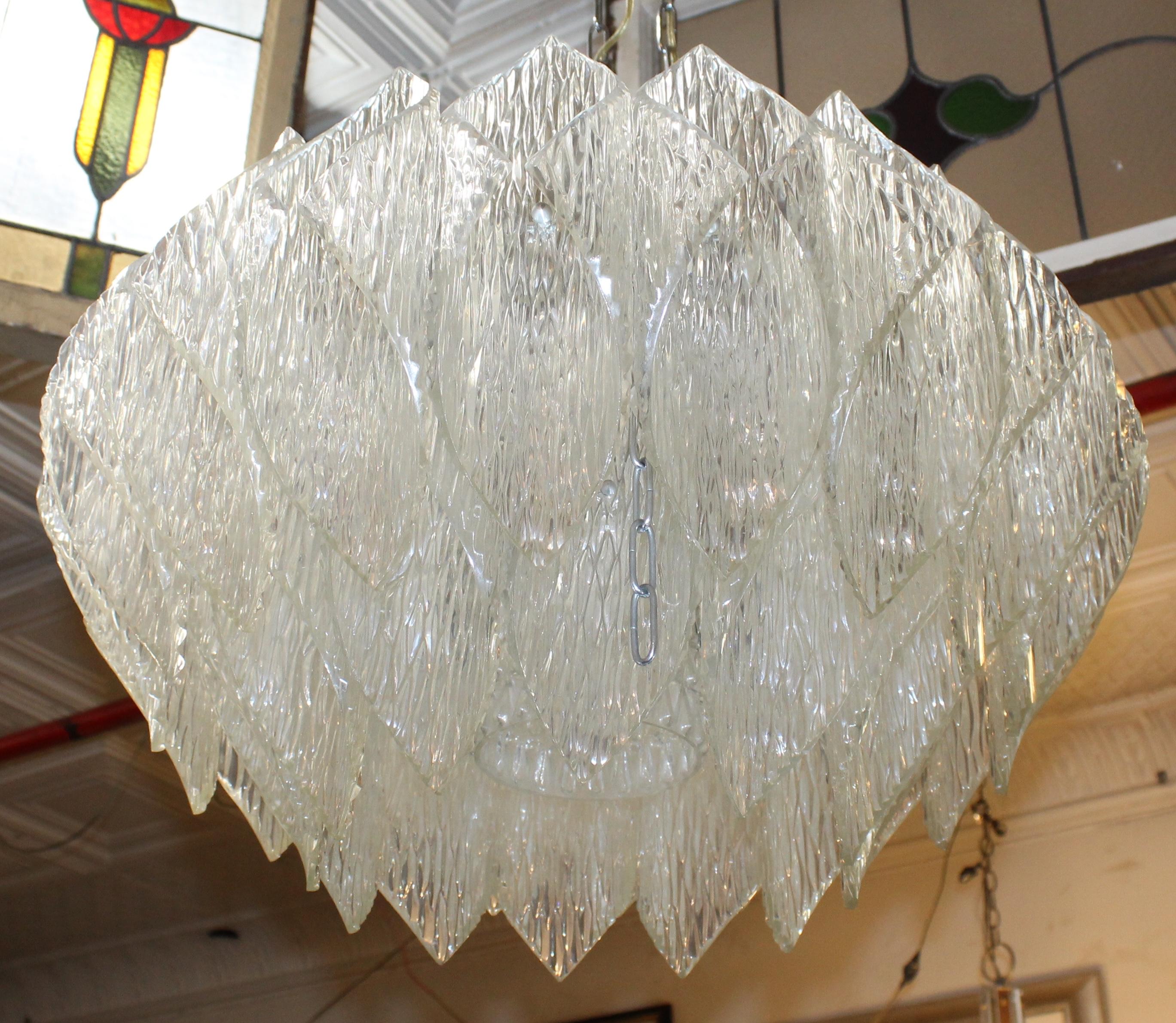 Mid-century chandelier by Kalmar Lighting featuring folded diamond shaped pieces of Bakelite acrylic with icicle texture. The semi-clear acrylic is used to shade the light, as well as reflect.
Please confirm location with seller NY or NJ
